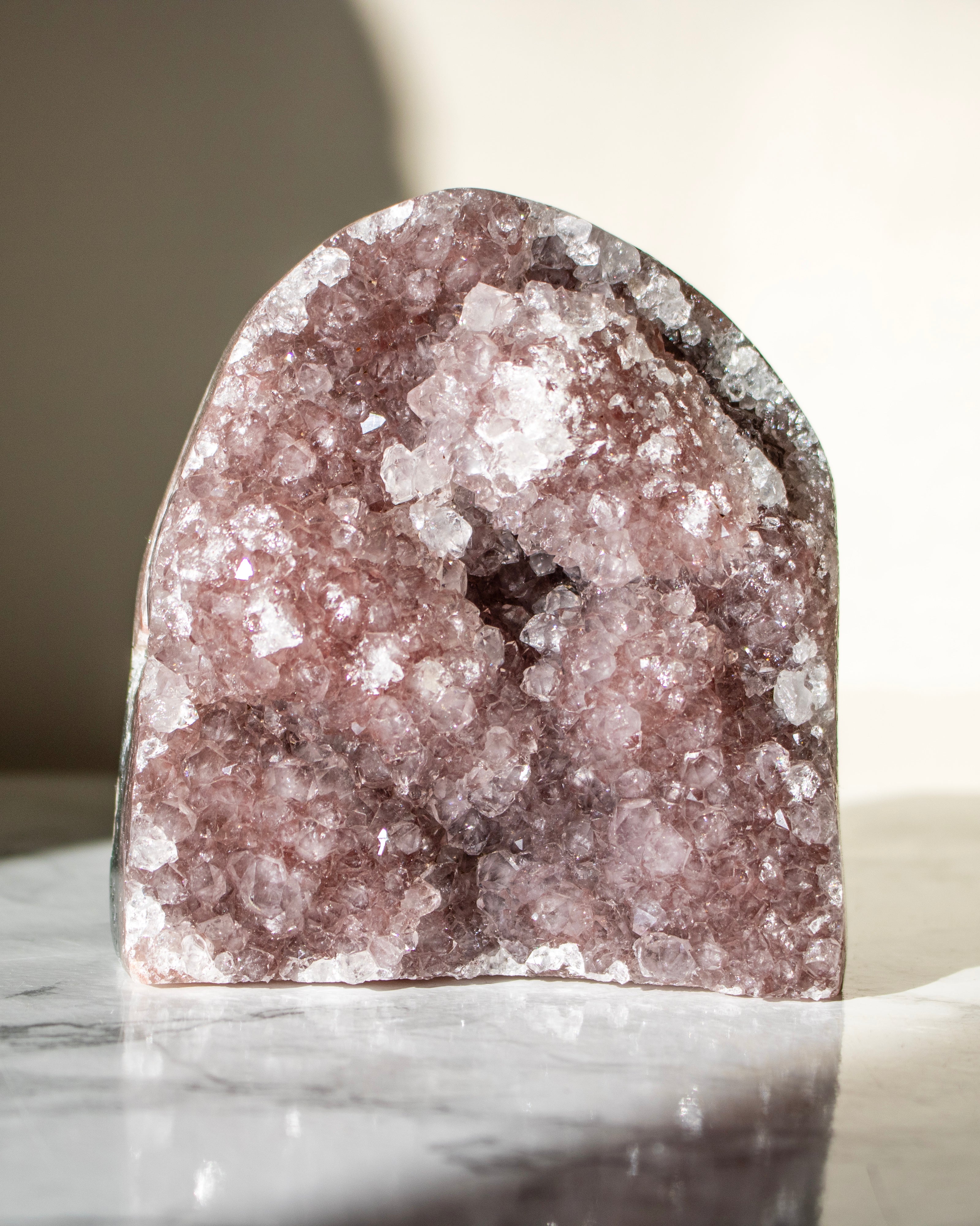 Crystal geode on a marble surface with a neutral background
