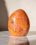 Orange stone with marbled pattern on a light background