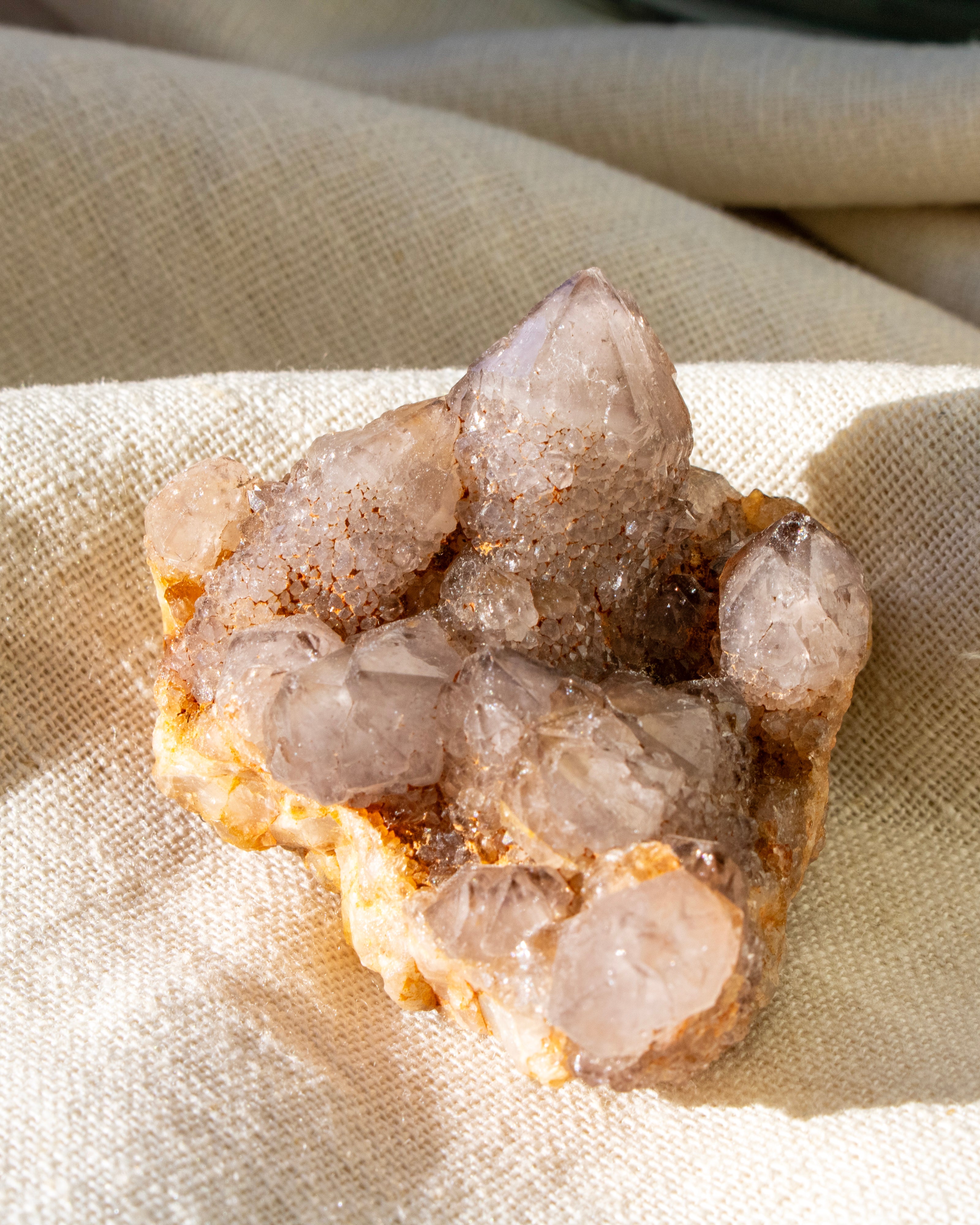 Crystal cluster on a beige fabric background