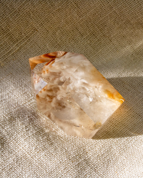 Crystal or mineral specimen on a textured fabric background