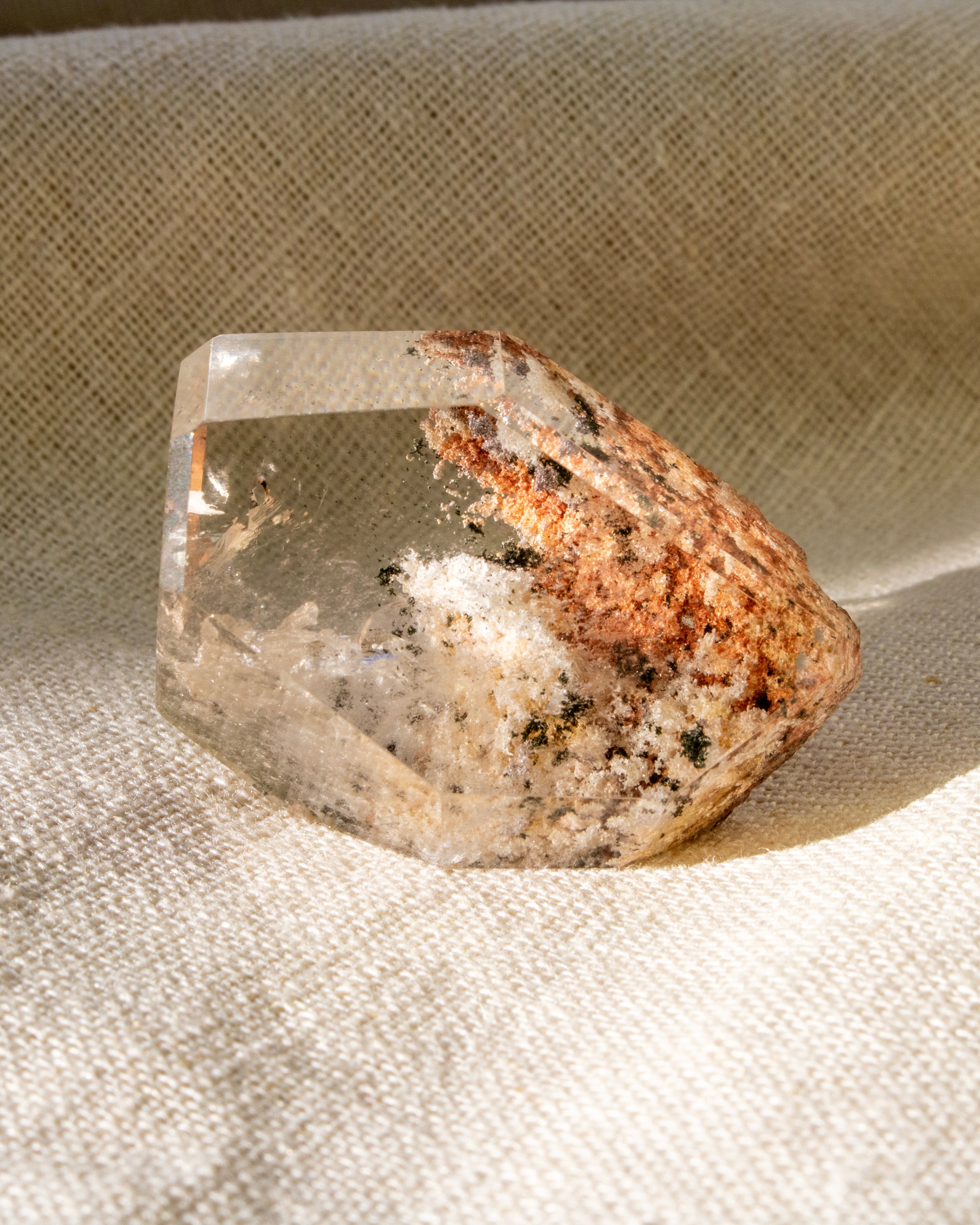 Clear crystal with brown and white on a textured beige background