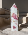a tall pointed white stone with pink areas 