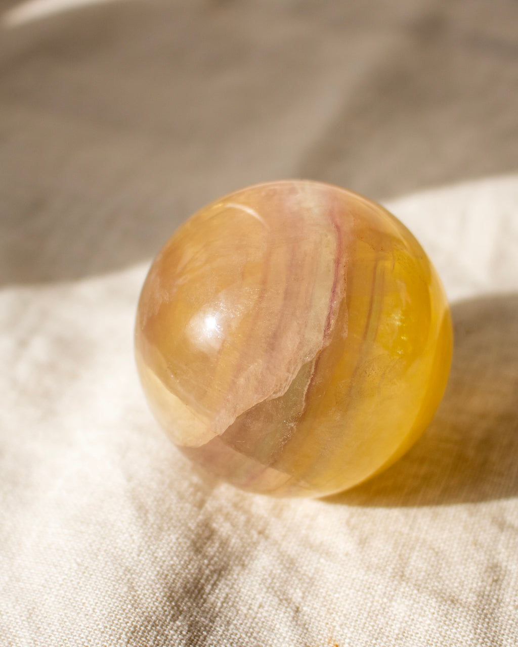 a yellow crystal ball on a linen fabric background