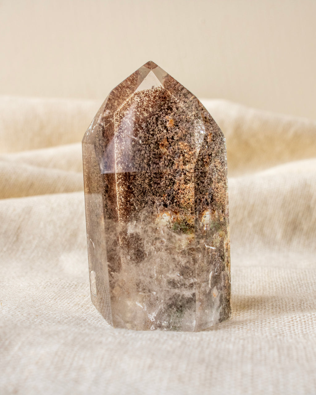garden quartz crystal on a textured beige surface
