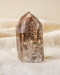 garden quartz crystal on a textured beige surface