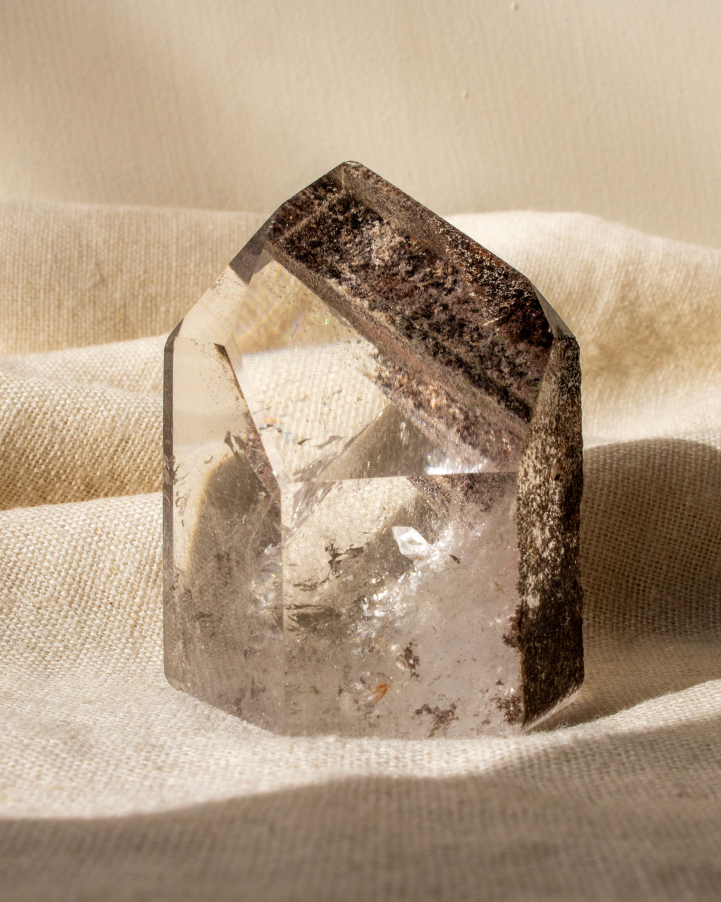garden quartz crystal on a textured beige surface