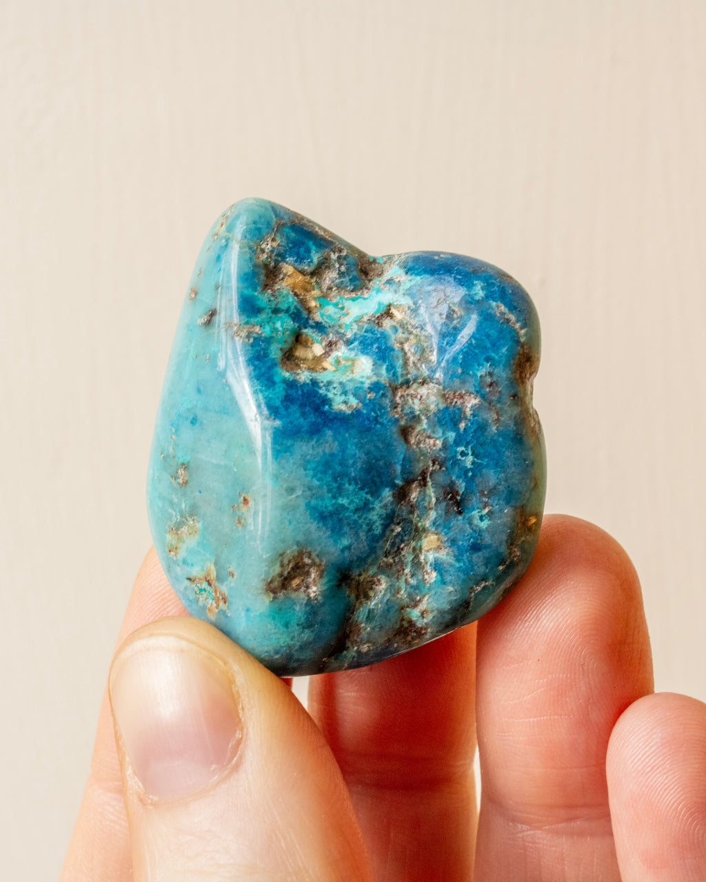 veined and mottled blue stone being held in fingers