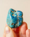 veined and mottled blue stone being held in fingers