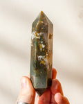 A part raw, part polished purple amethyst point with a flat cut base.