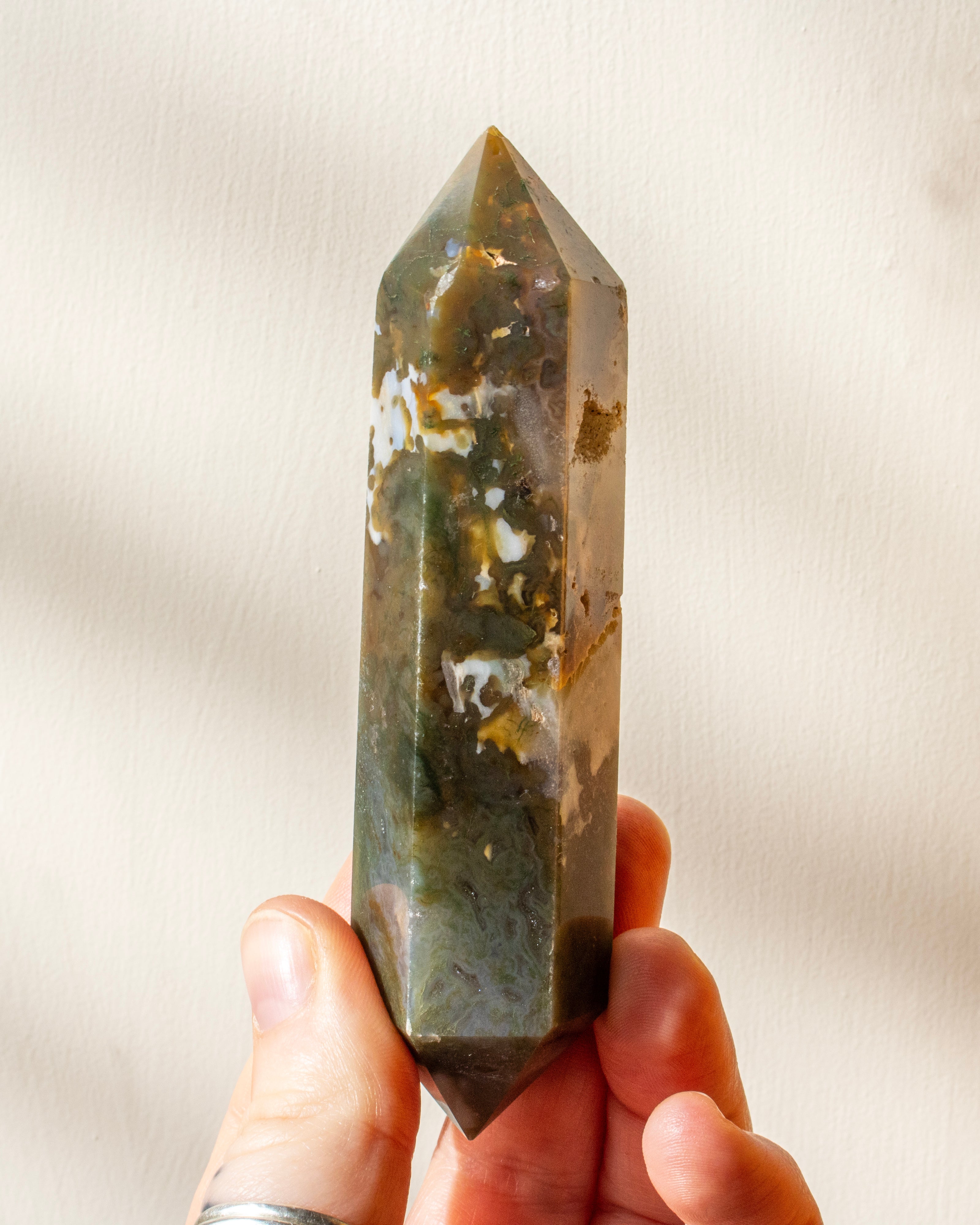 A part raw, part polished purple amethyst point with a flat cut base.