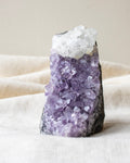 Amethyst crystal on a beige fabric background