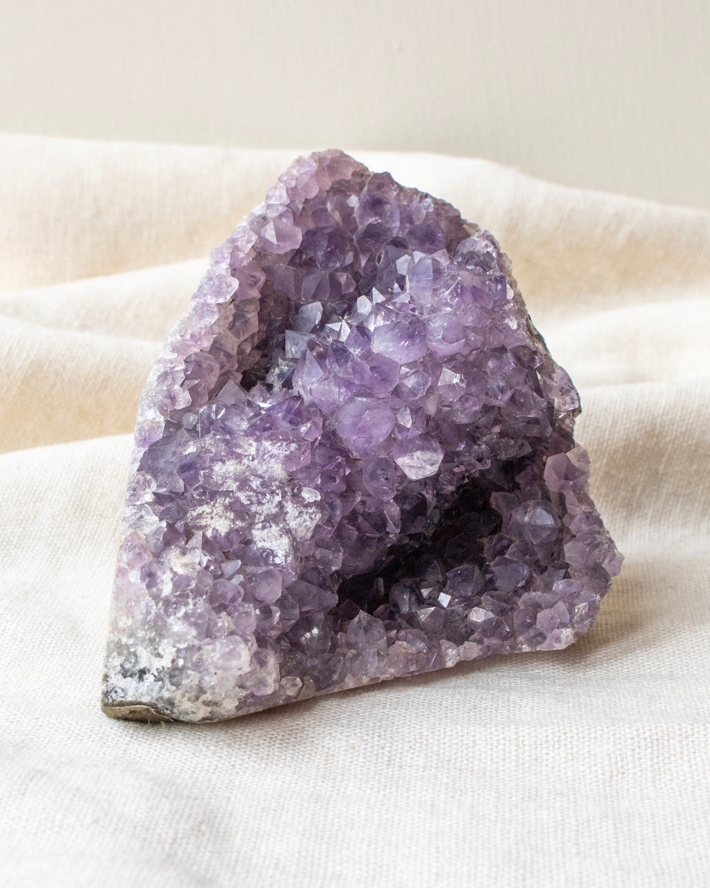 Amethyst crystal on a white fabric background