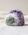 Amethyst crystal on a white fabric background