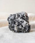 a black and white raw stone on a linen fabric background