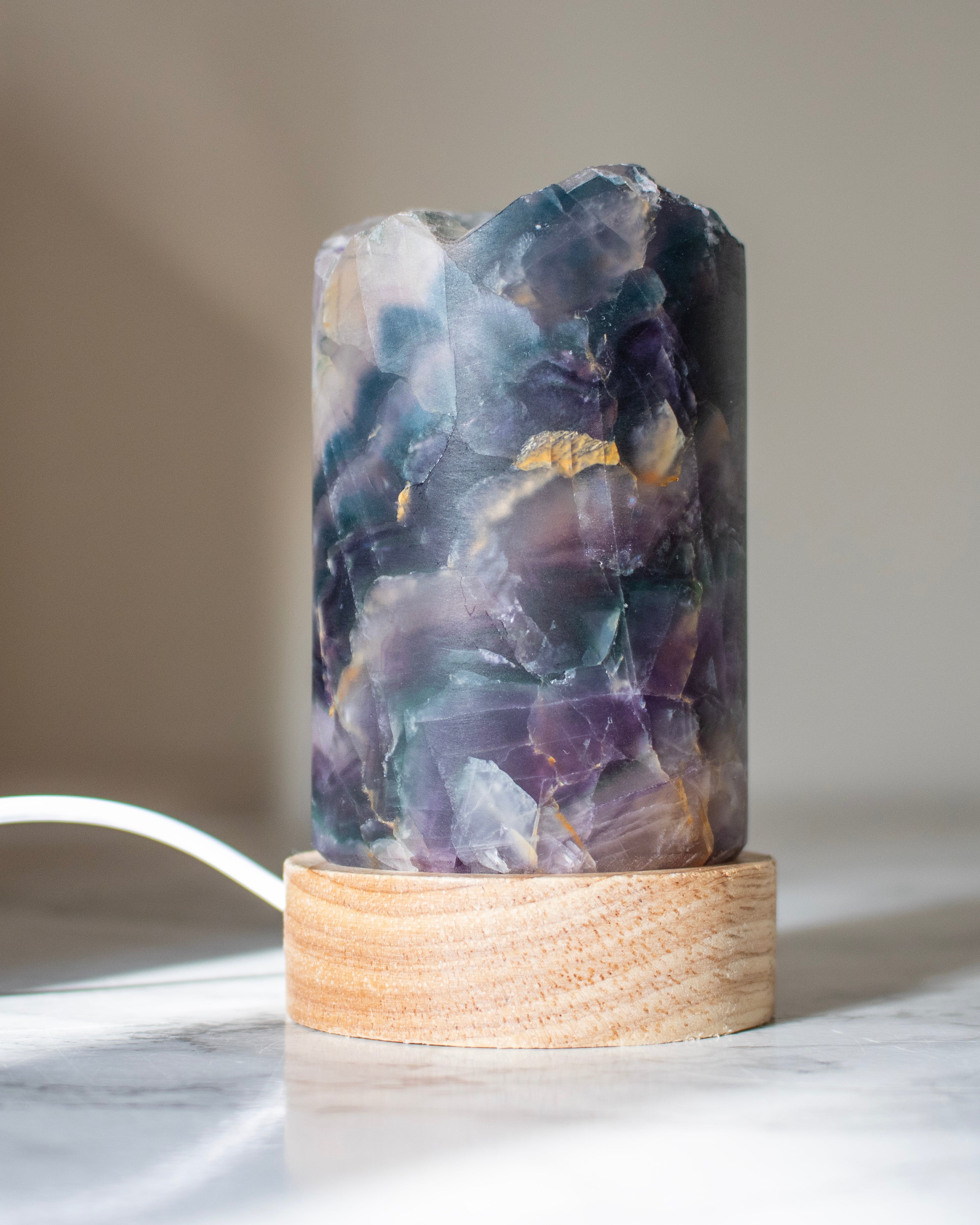 Decorative lamp with a natural stone base on a neutral background