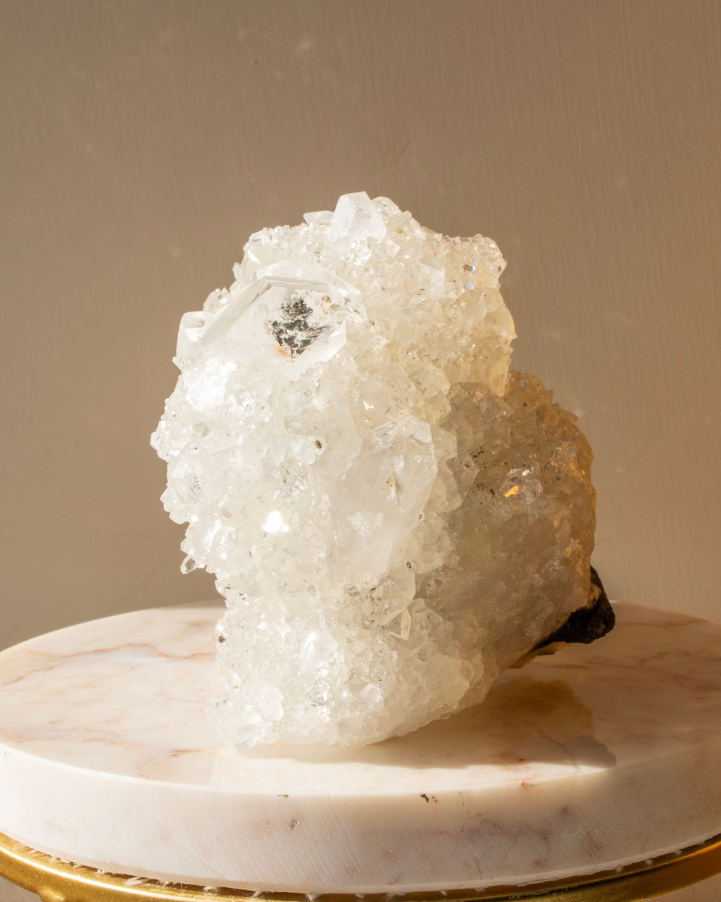 Crystal formation on a marble base with a neutral background