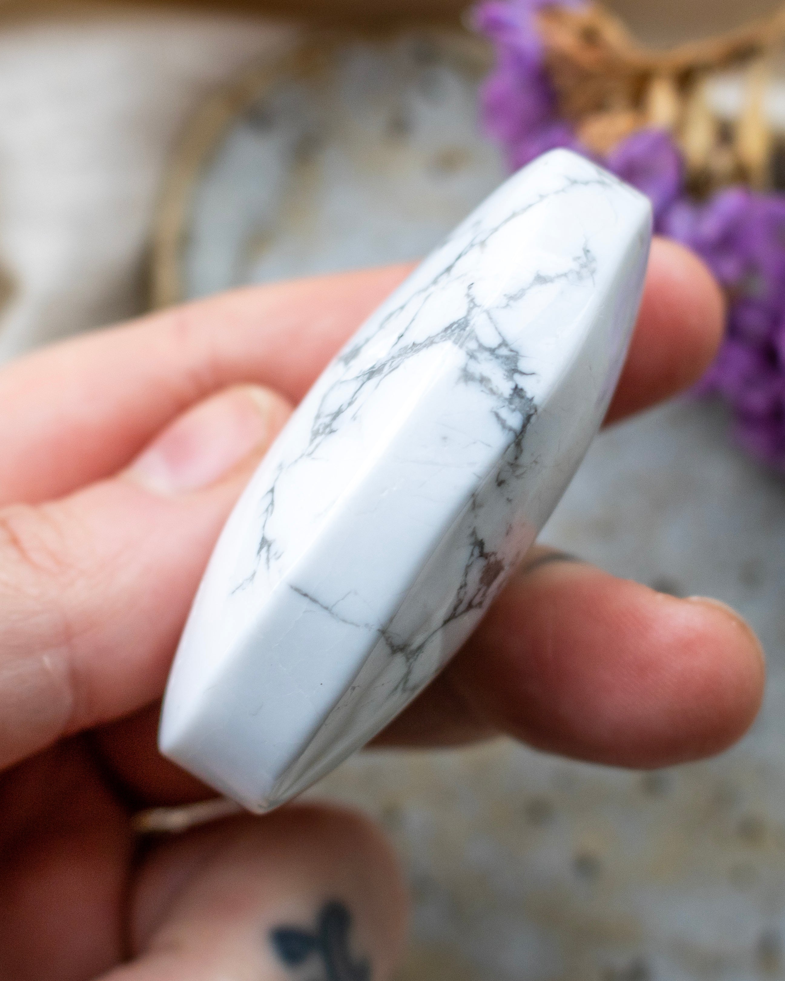 Marble-patterned white object held in a hand with a blurred background