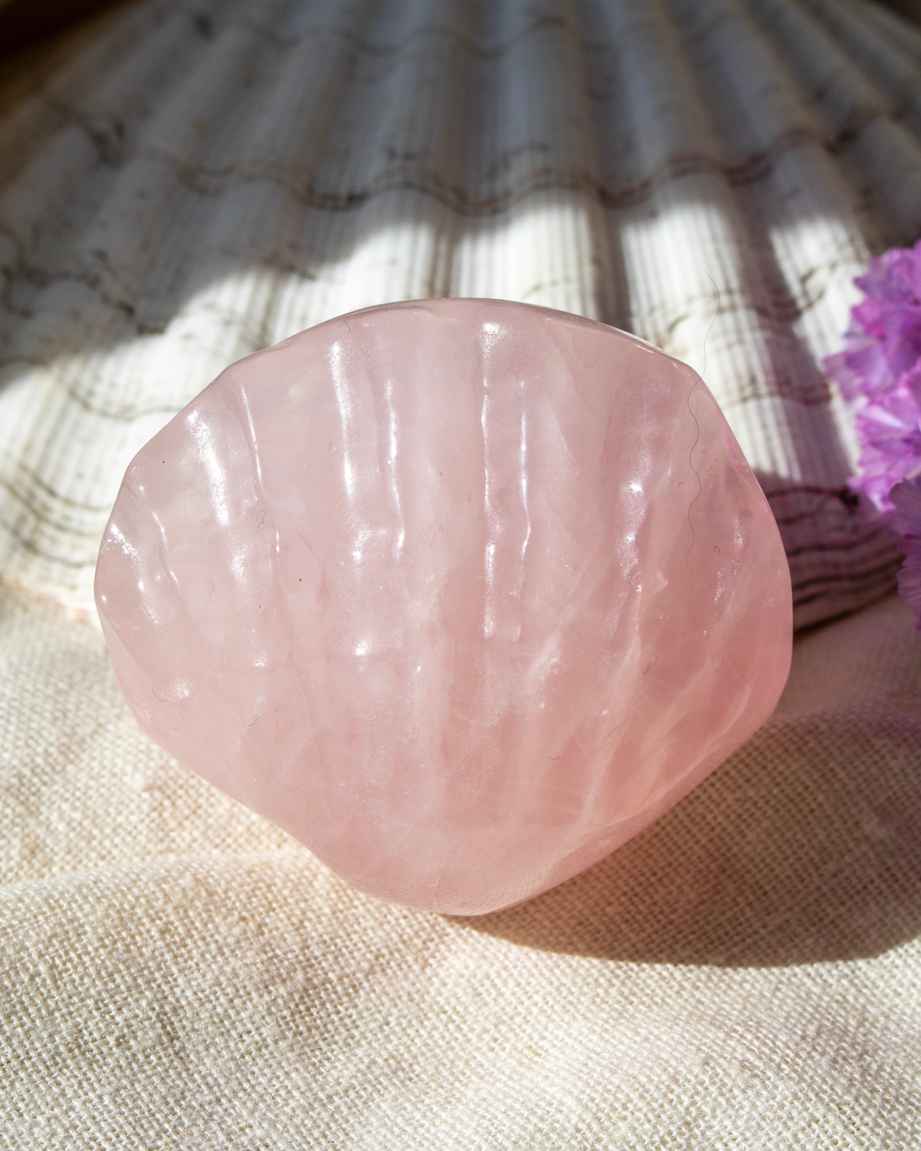 Pink stone on a textured fabric background