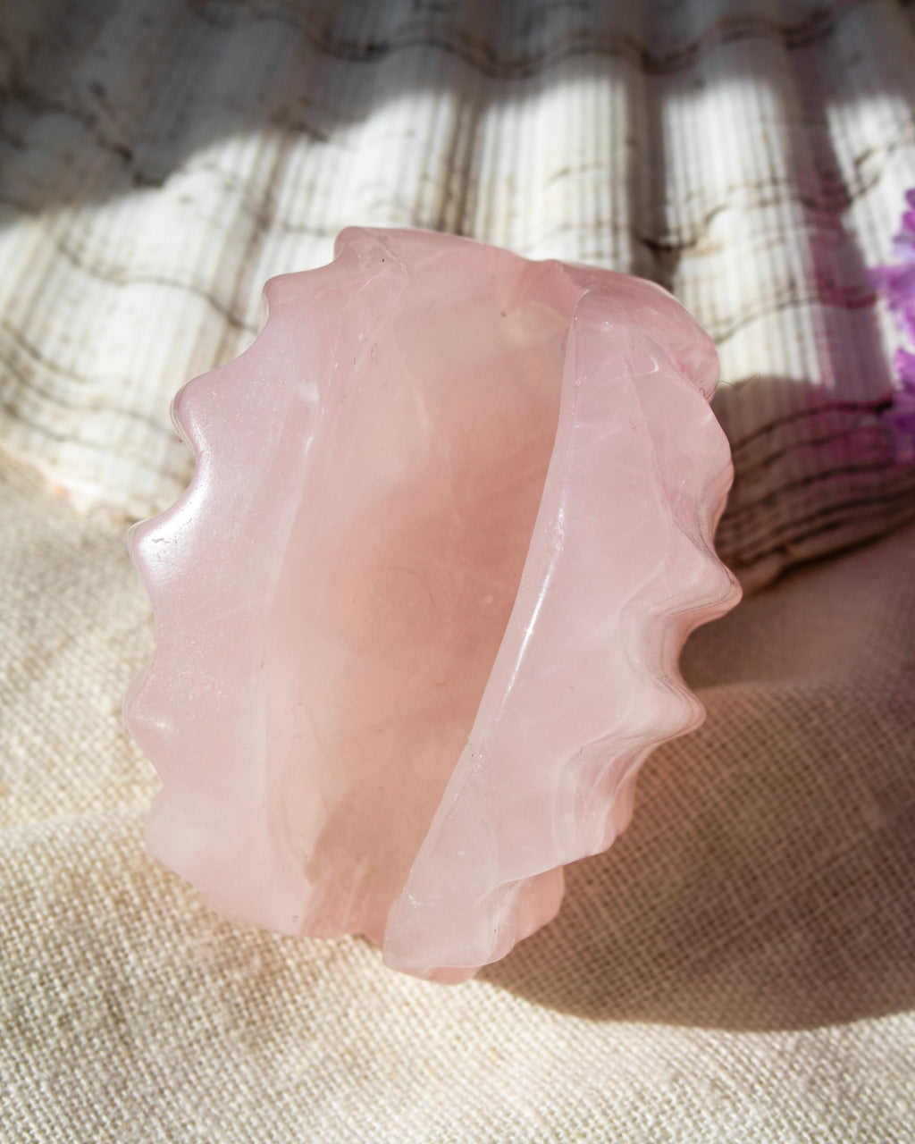 Pink stone on a textured fabric background