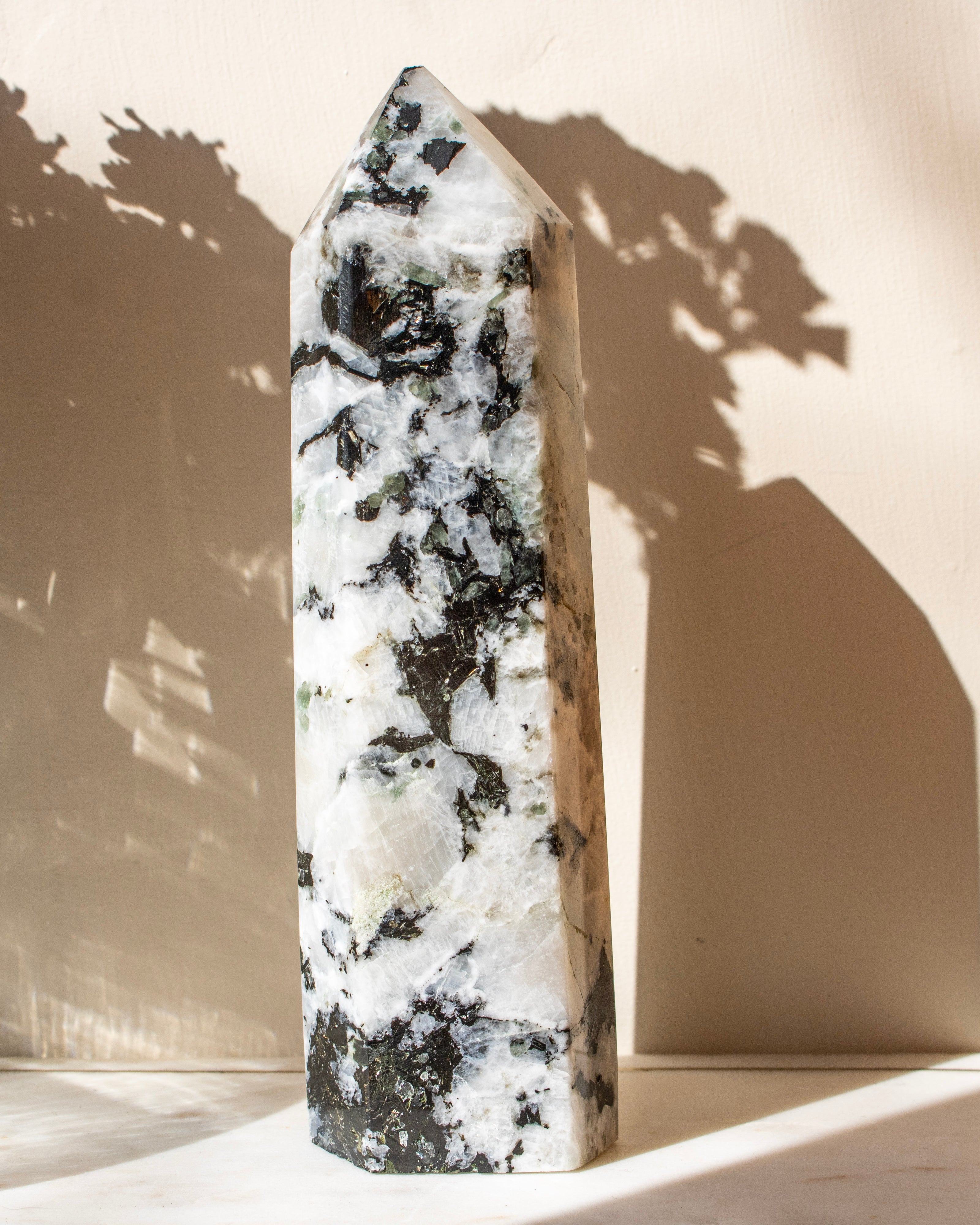 Crystal tower with black and white patterns on a beige background