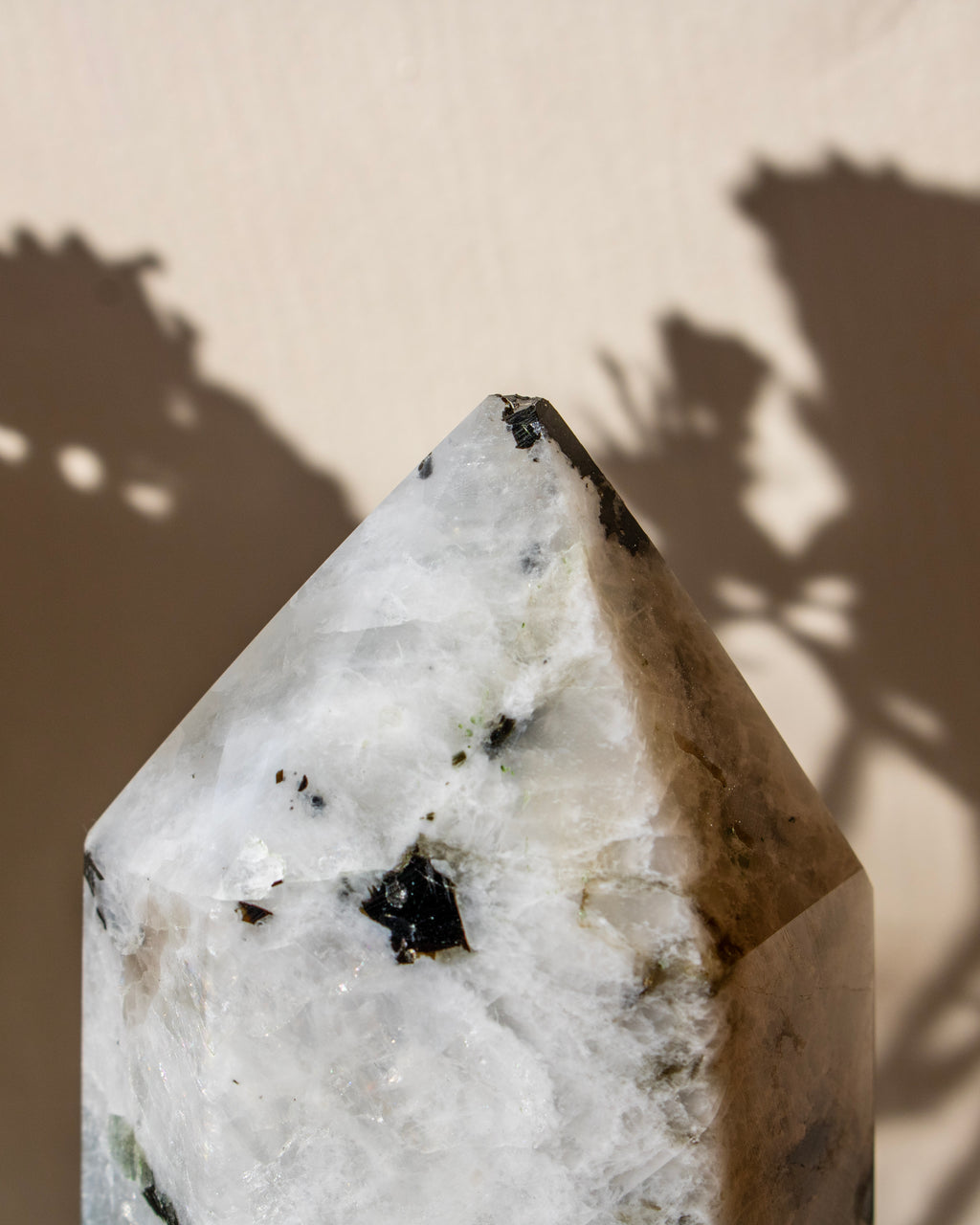 Crystal or mineral specimen with a rough, natural surface on a neutral background