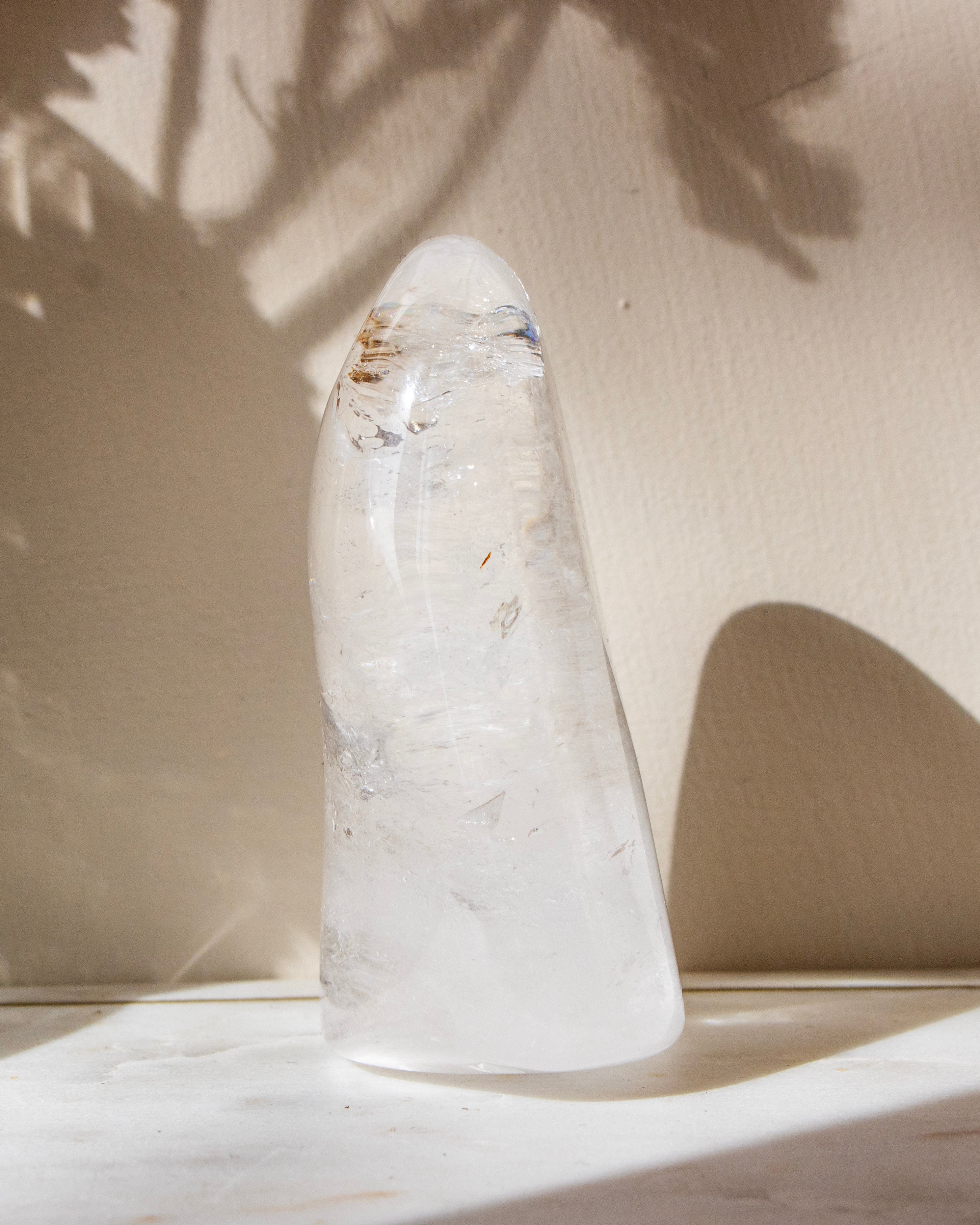 a clear quartz stone against a beige background