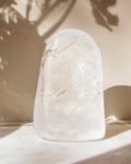 a clear quartz stone against a beige background