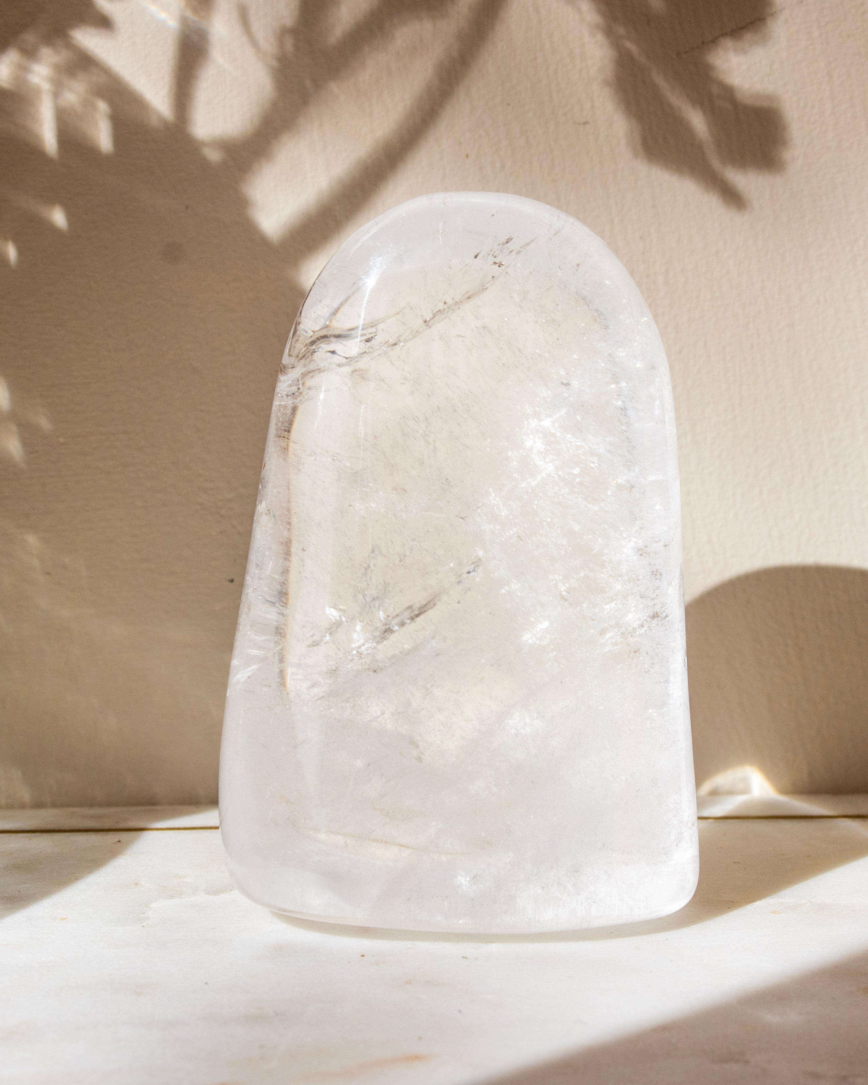 a clear quartz stone against a beige background