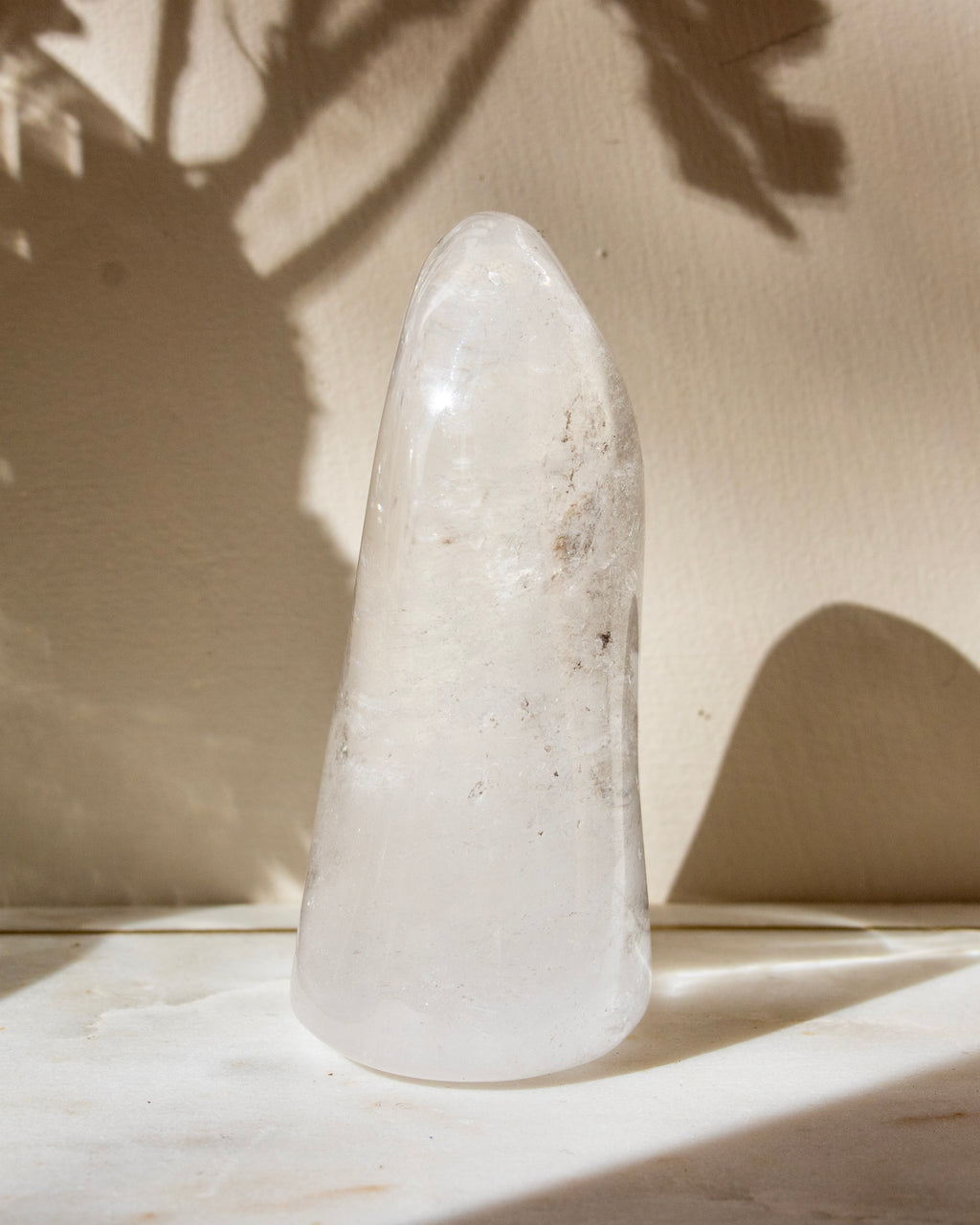 a clear quartz stone against a beige background