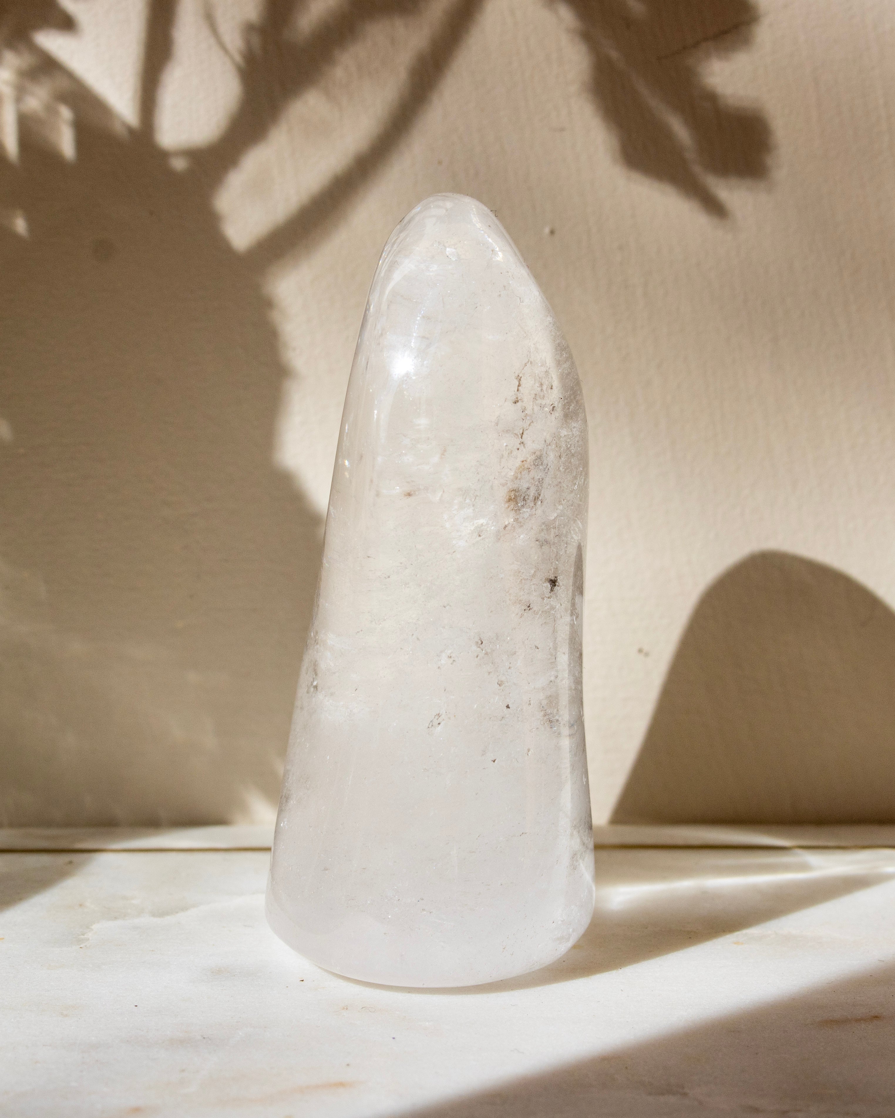 a clear quartz stone against a beige background