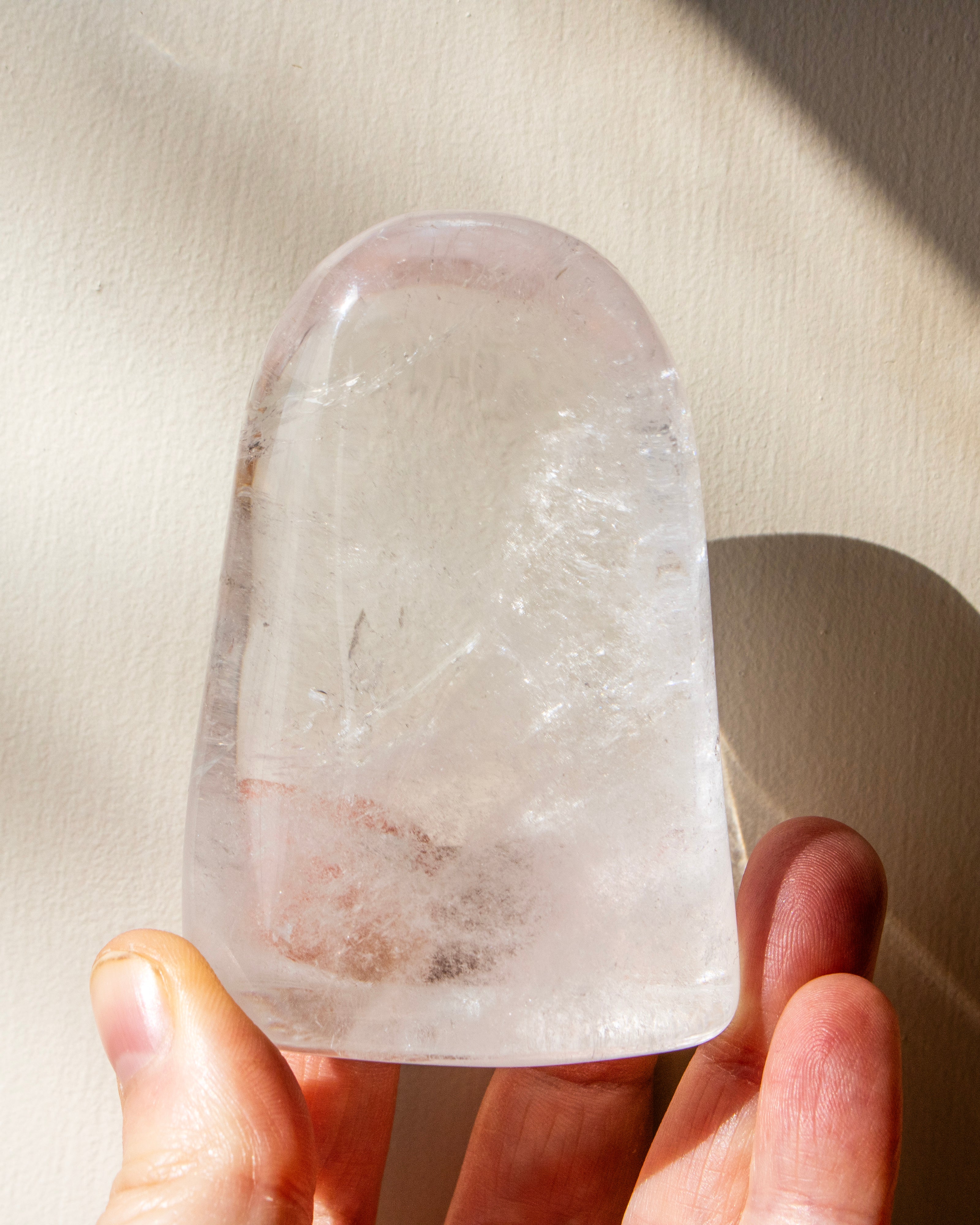 a clear quartz stone against a beige background
