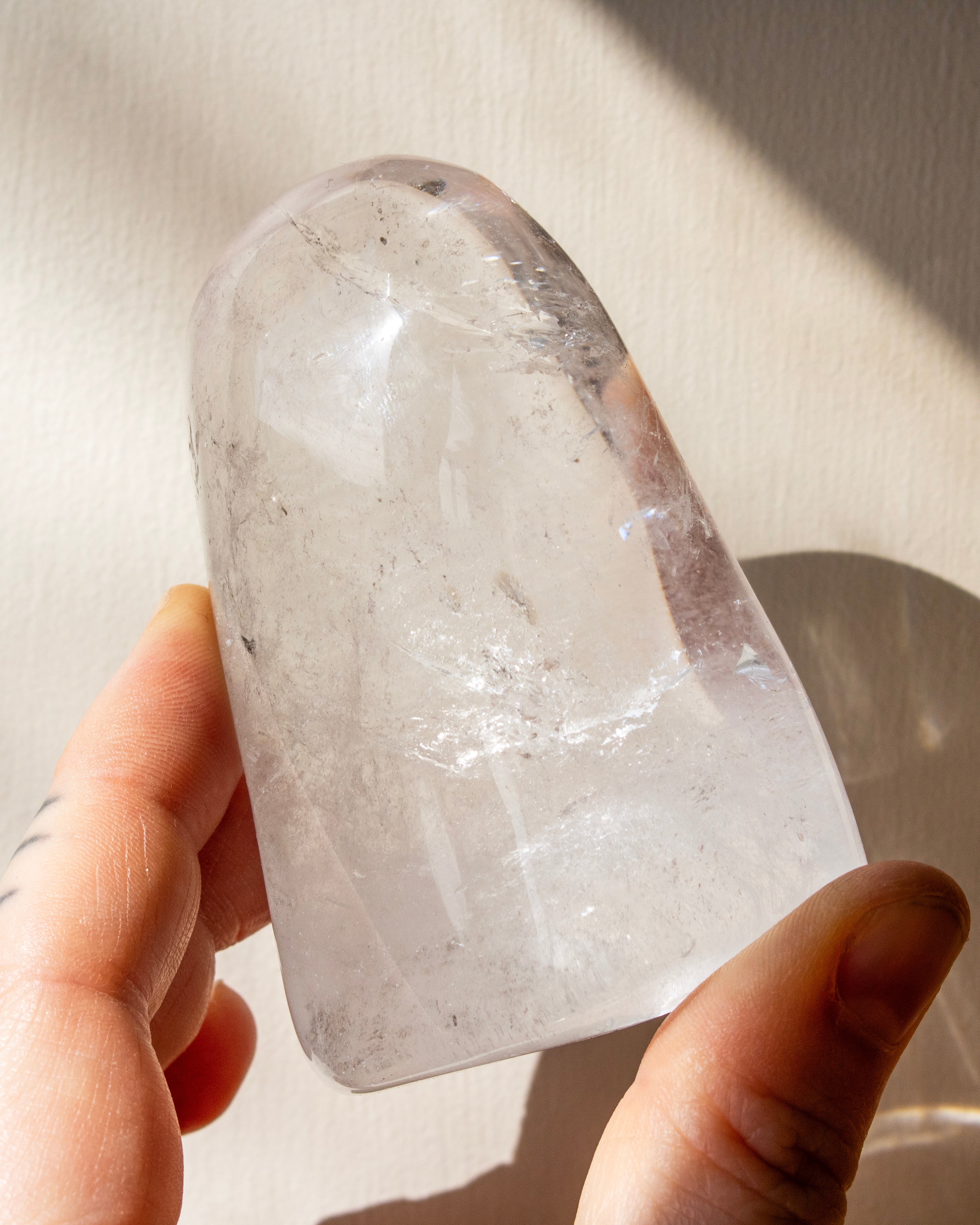 a clear quartz stone against a beige background