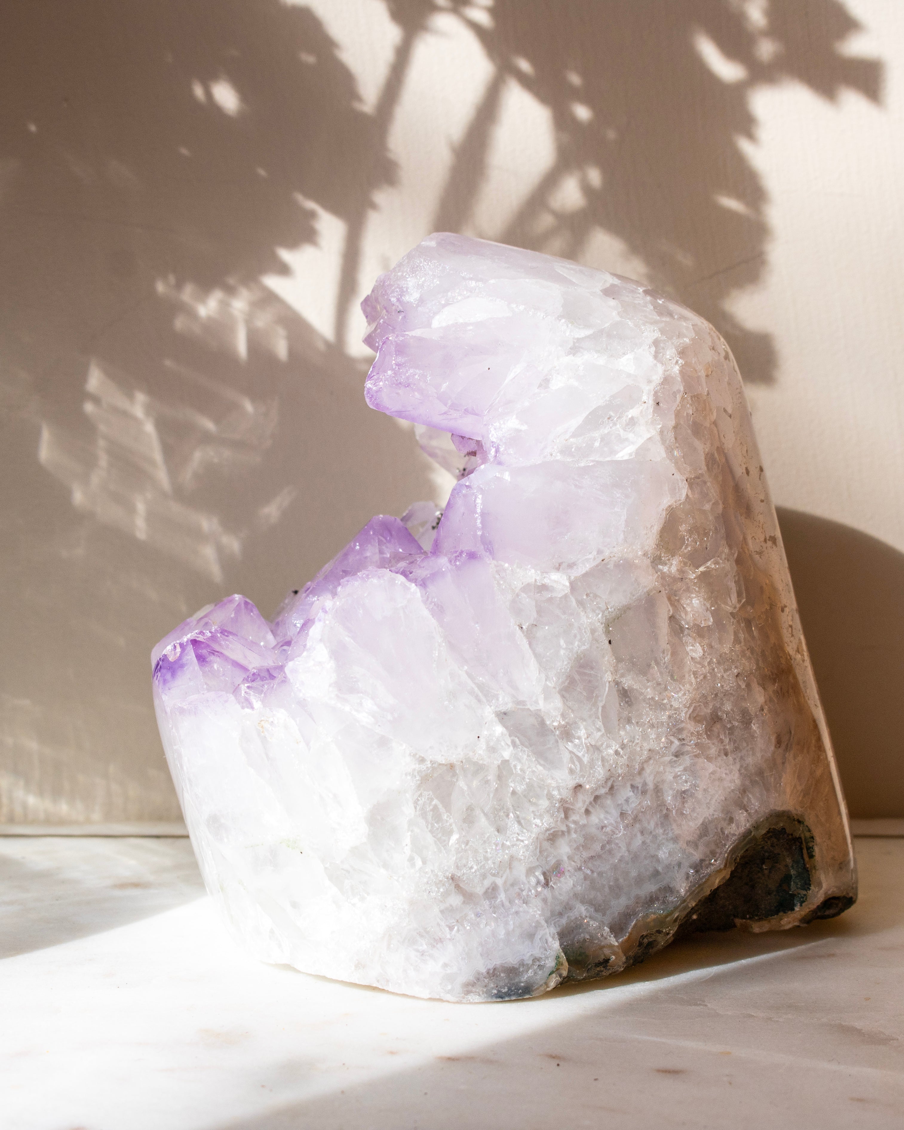 Amethyst crystal on a light surface with a neutral background