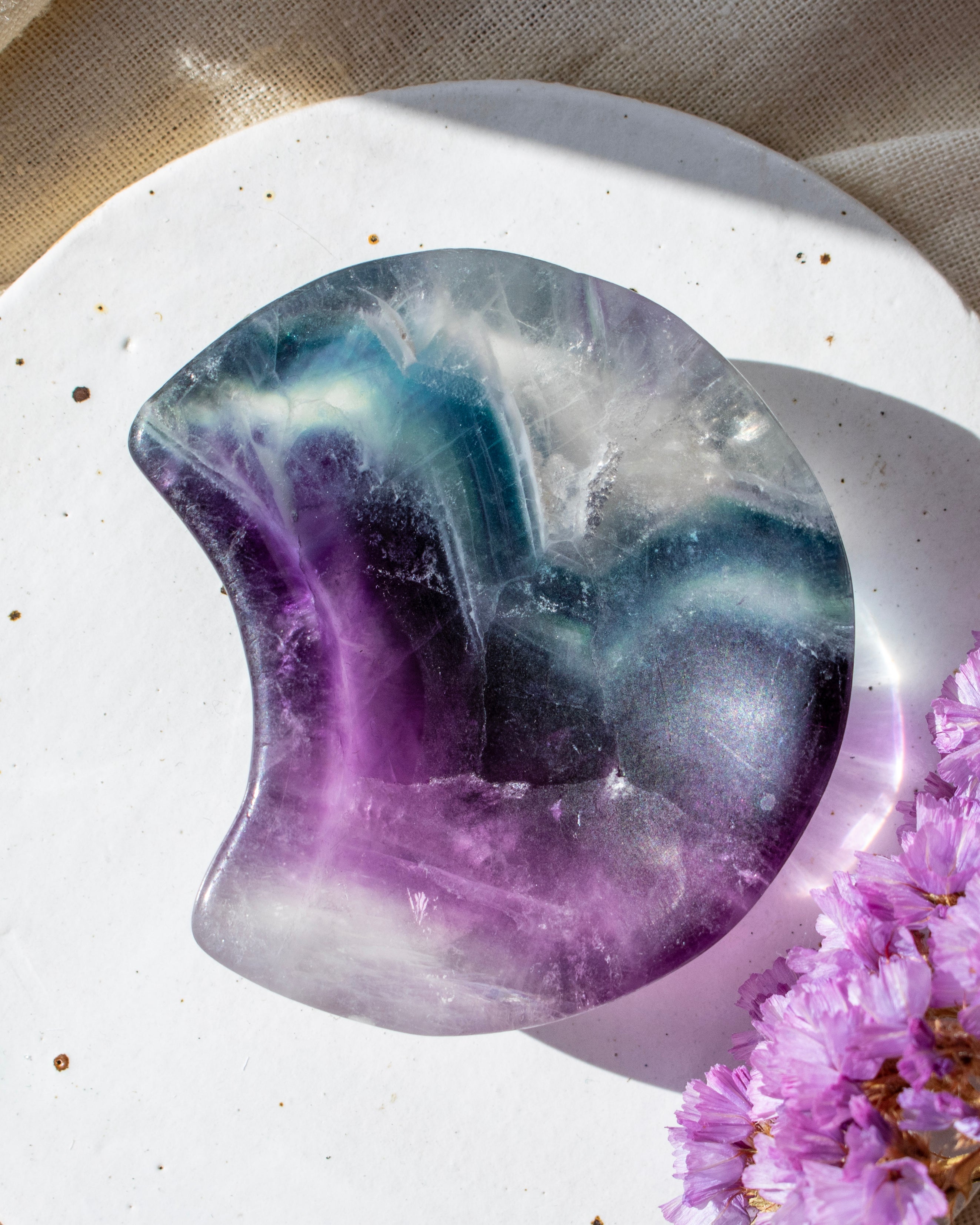 Crystal stone with purple and white colors on a light background