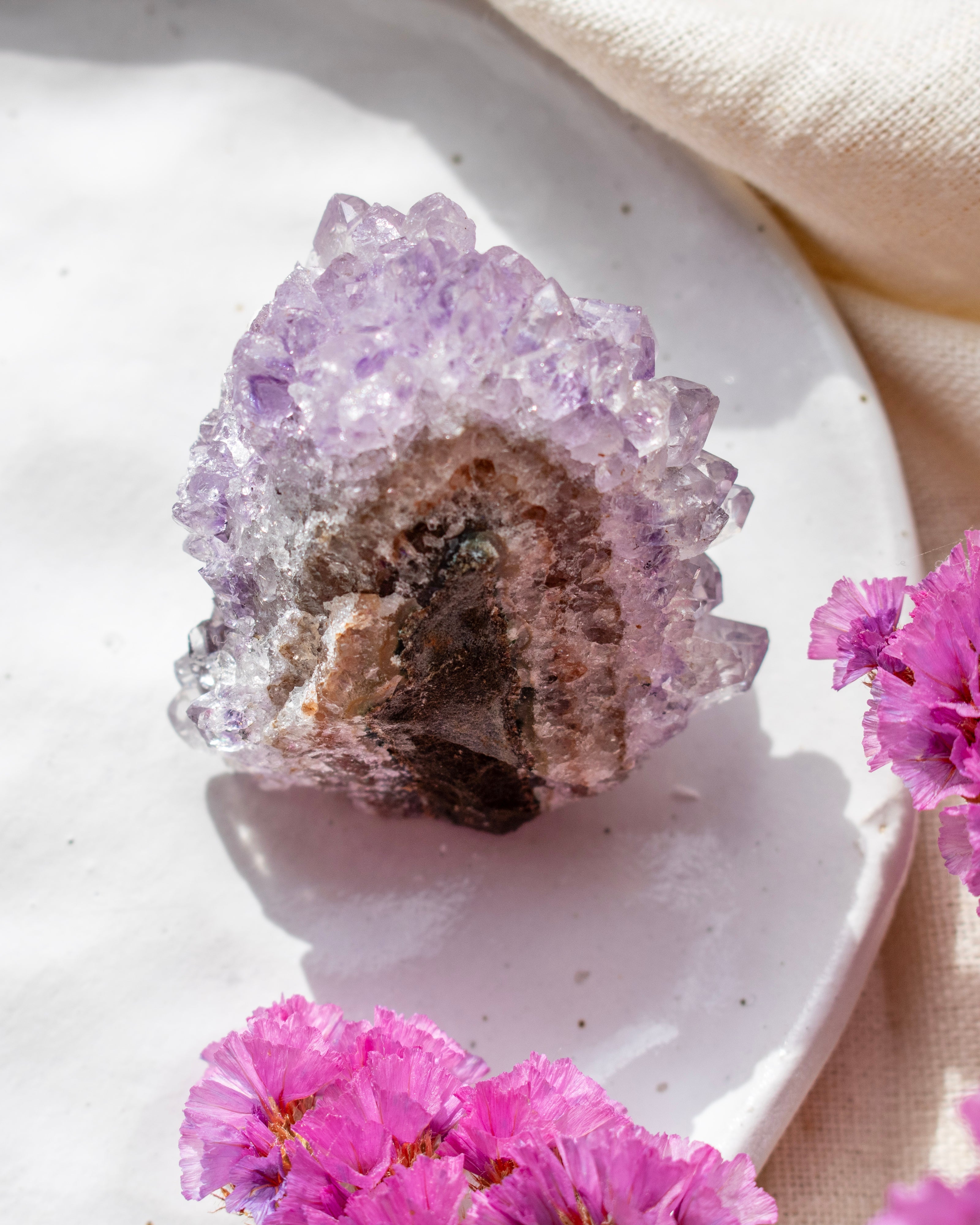 Crystal formation on a white plate with pink flowers