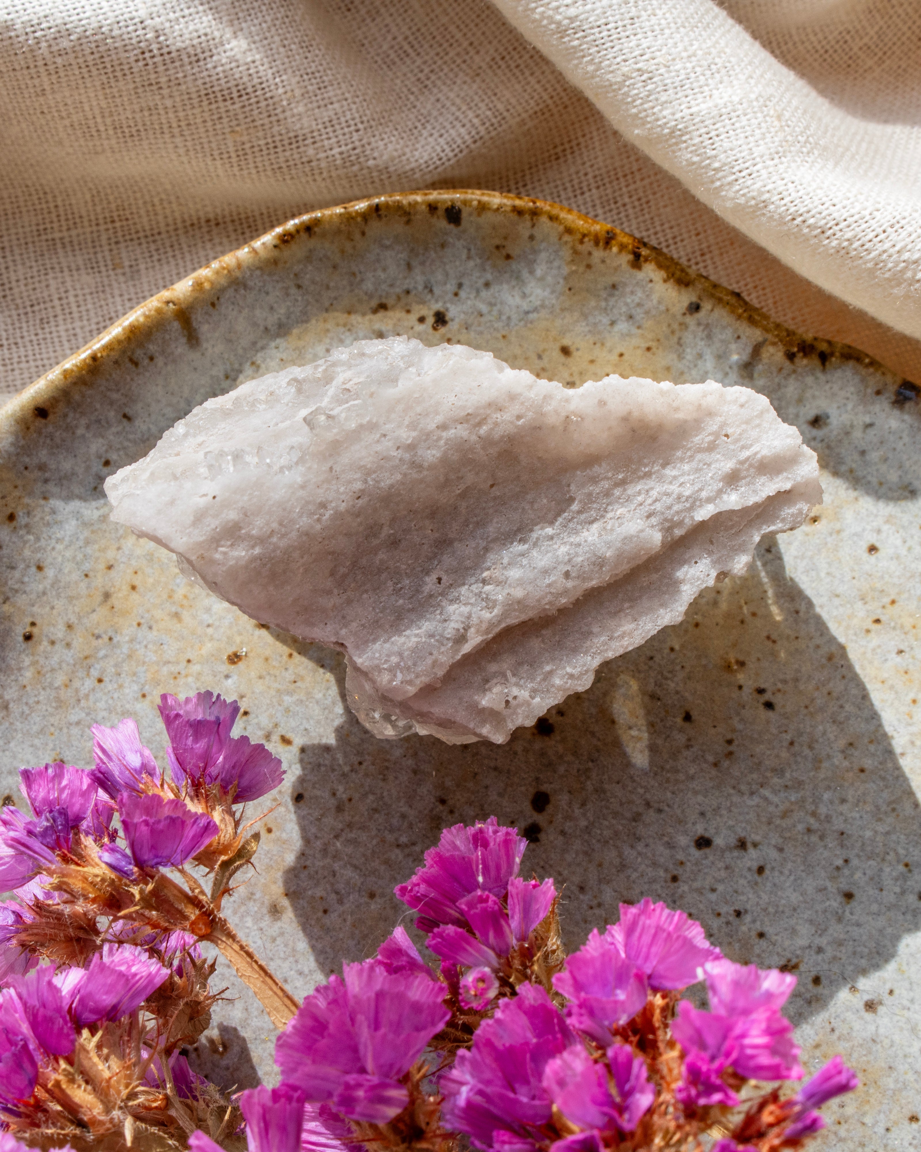 Mineral on a textured plate with pink flowers