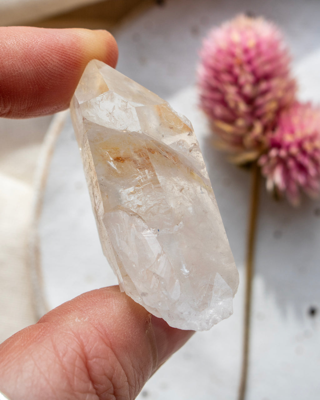 a quartz point being held with fingers