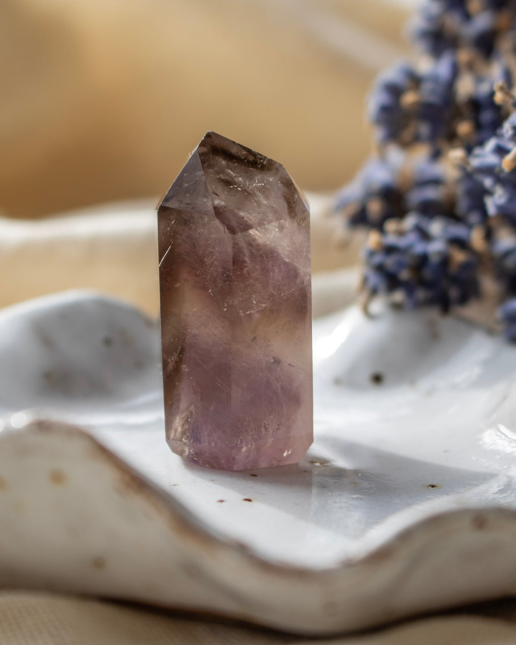 Crystal on a white surface with blurred background