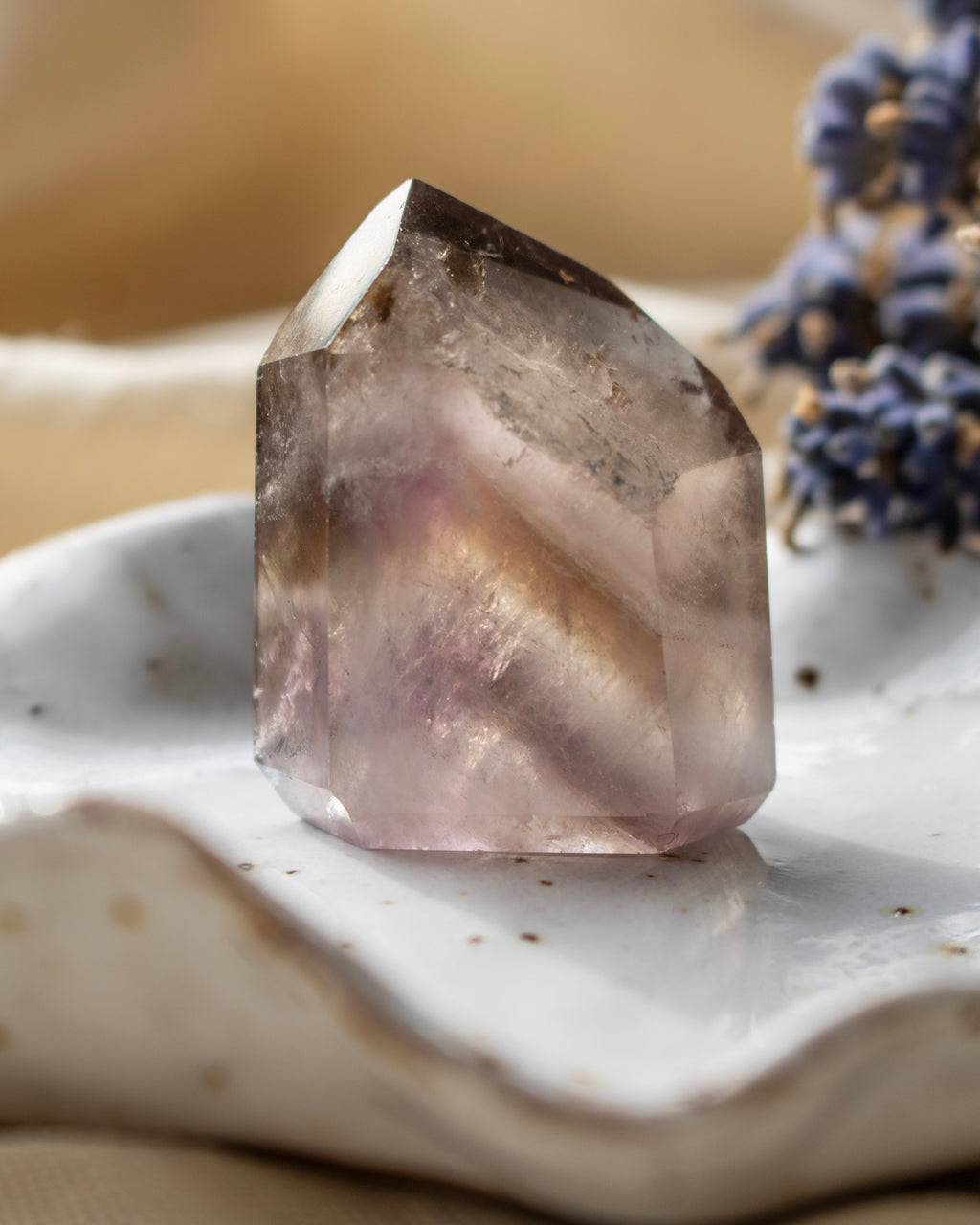 Clear crystal on a textured surface with blurred background
