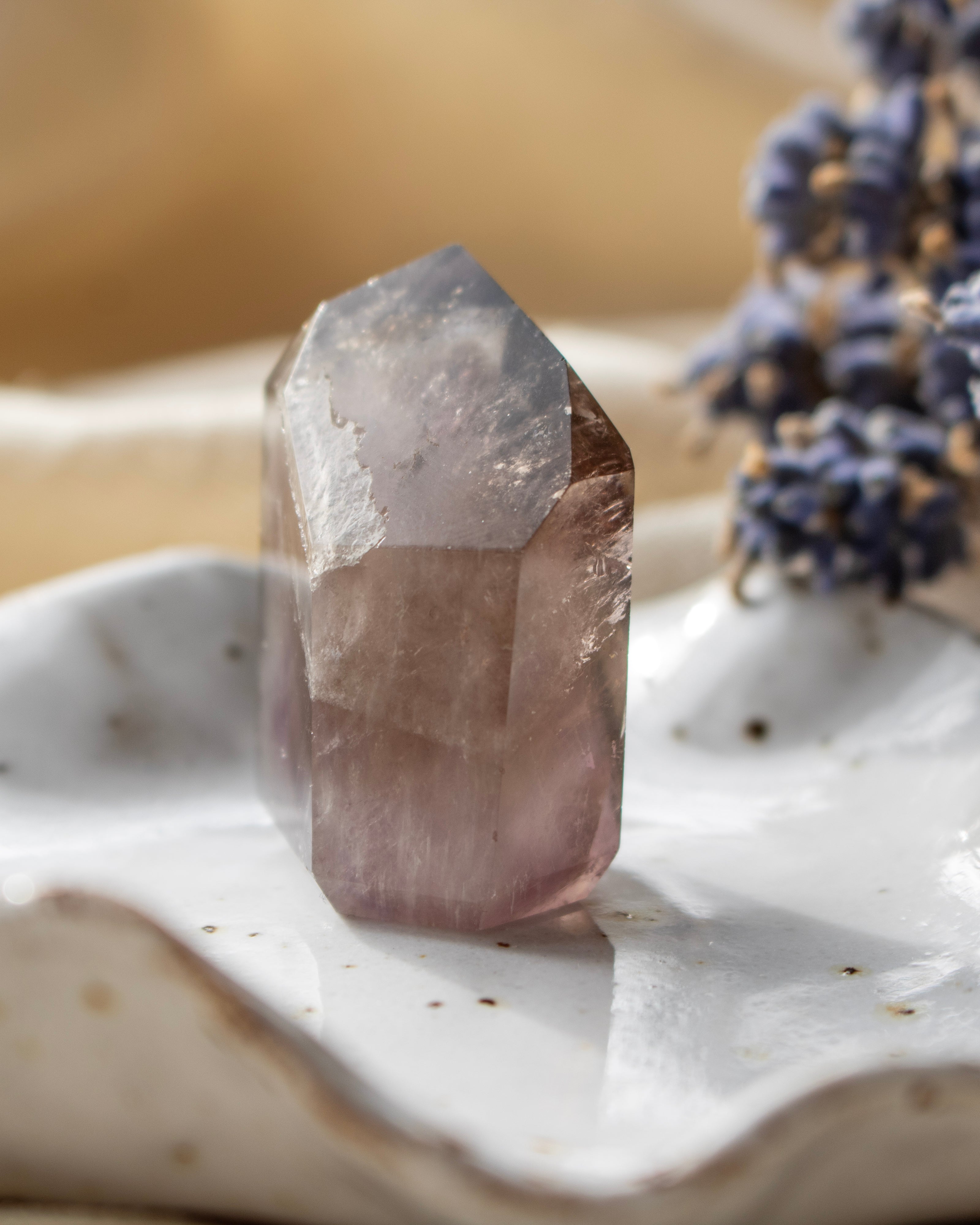 Crystal on a white surface with a blurred background