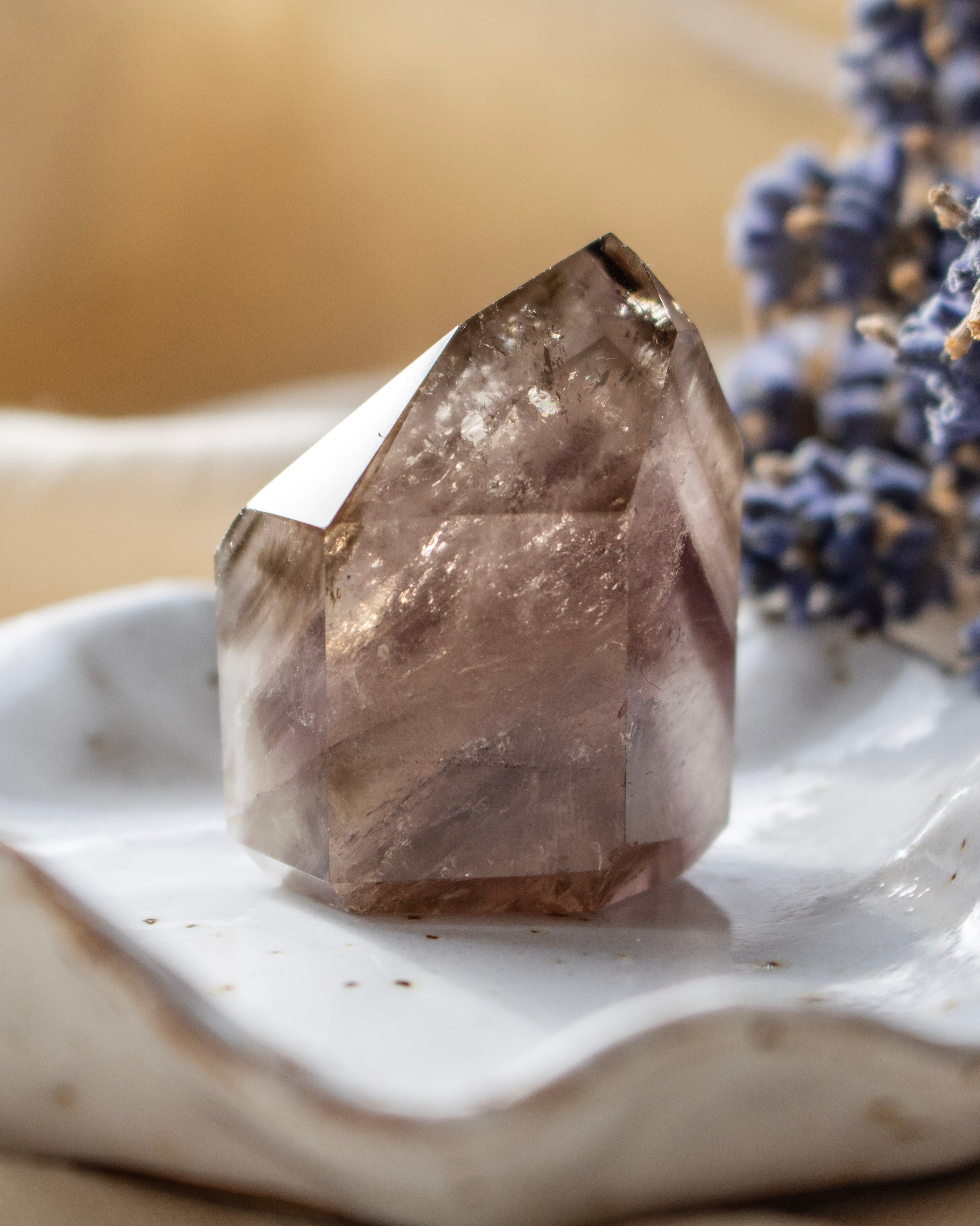 Crystal on a white surface with blurred background