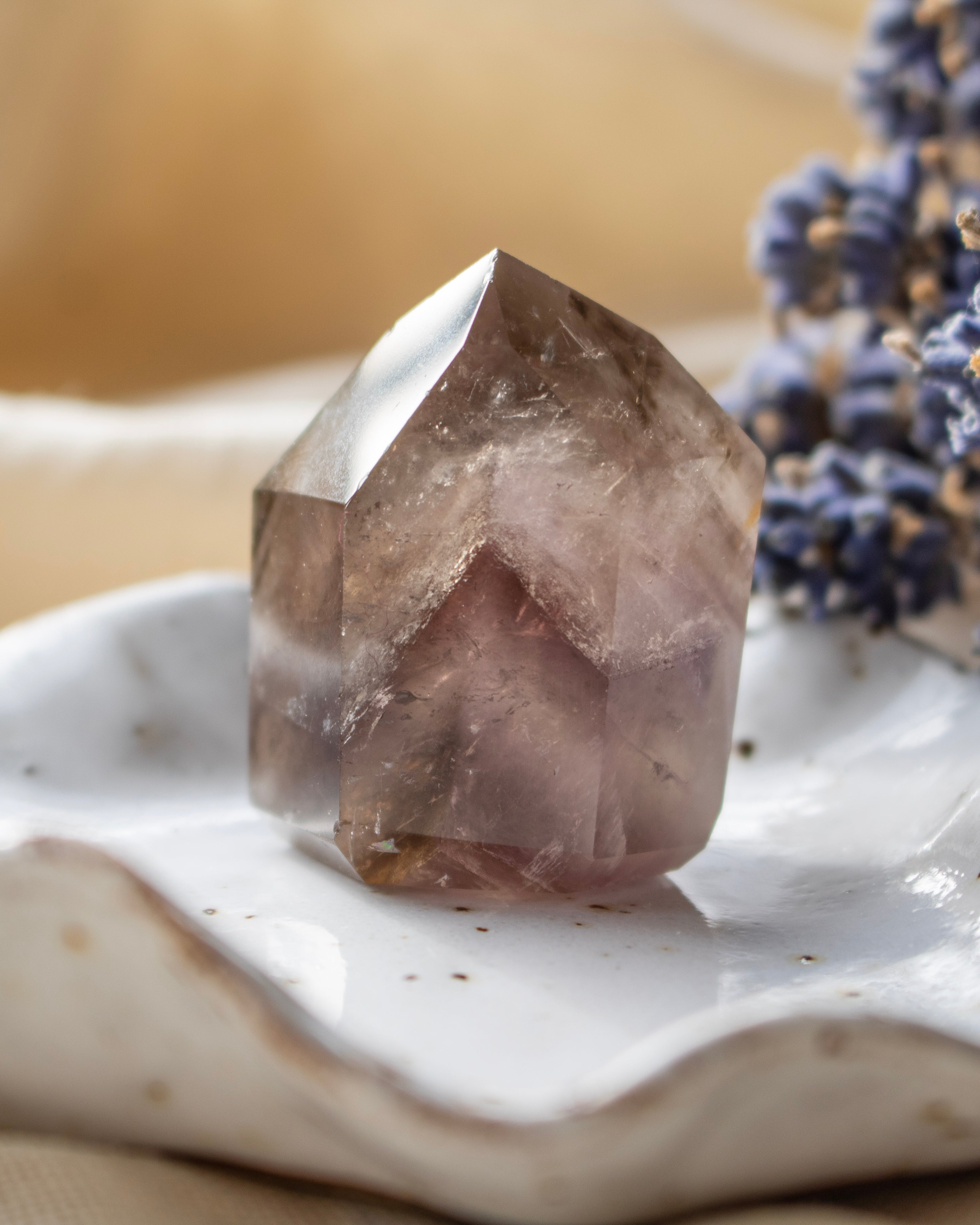 Crystal on a white surface with a blurred background