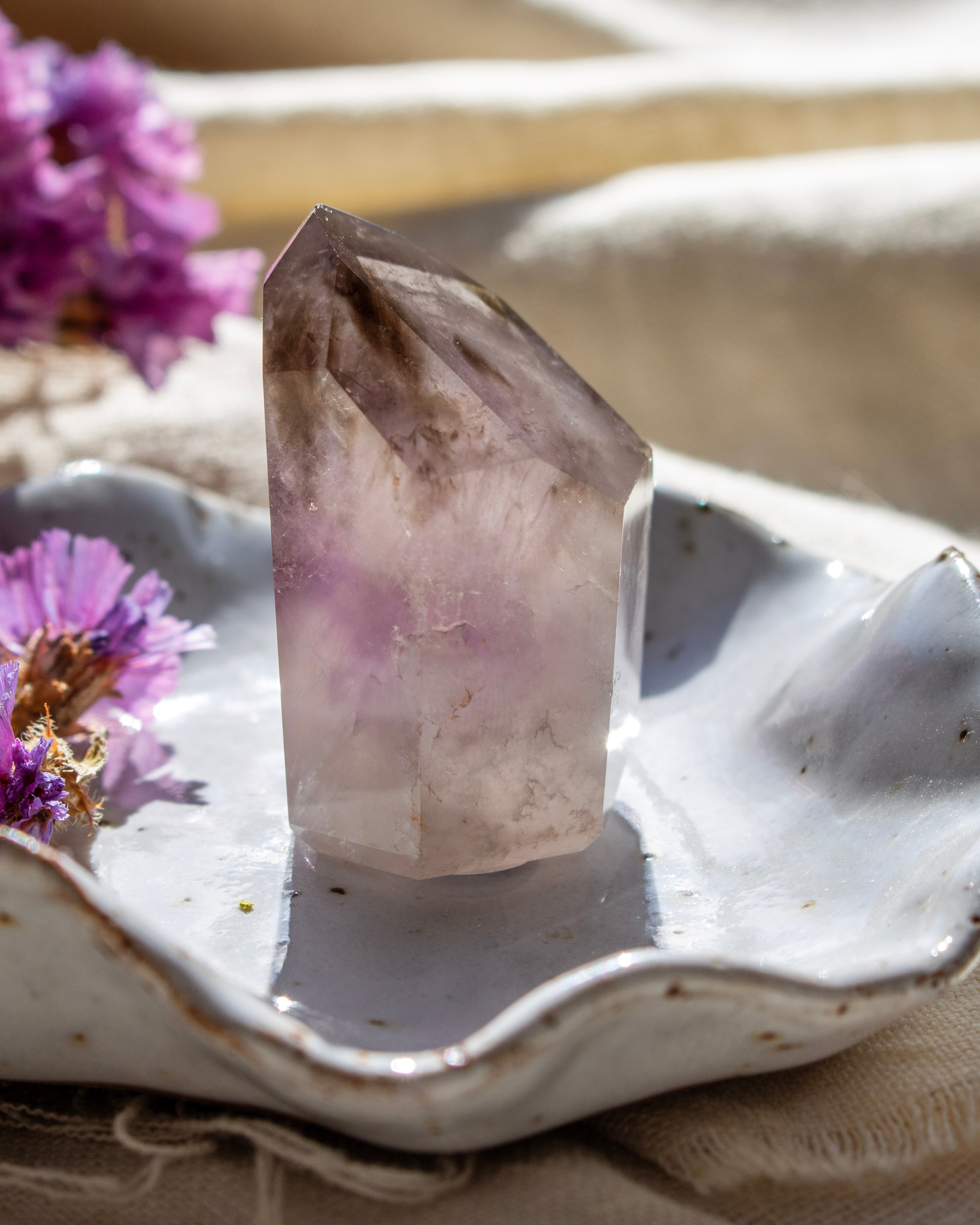 Crystal on a white dish with purple flowers