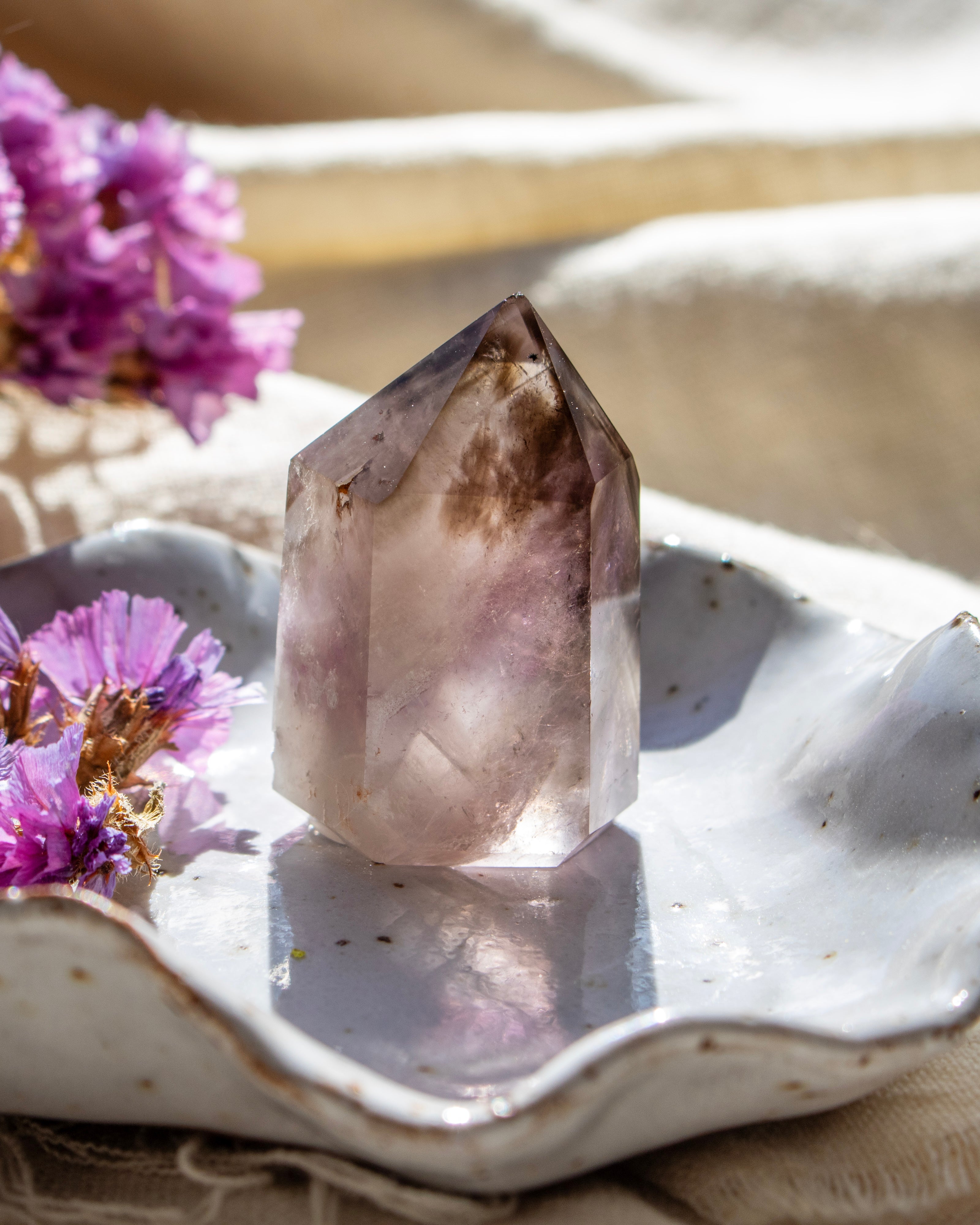 Crystal on a white dish with purple flowers