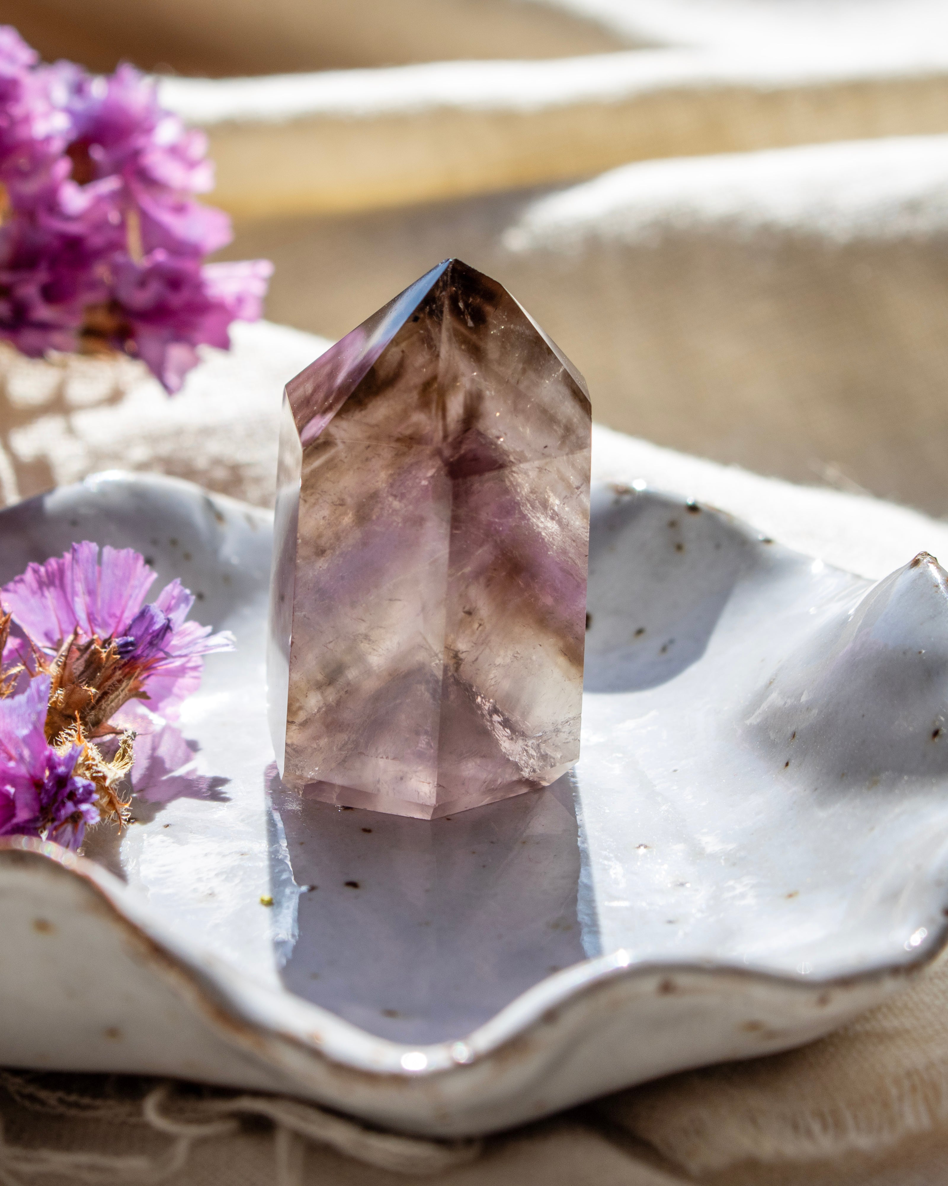 Crystal on a decorative plate with purple flowers