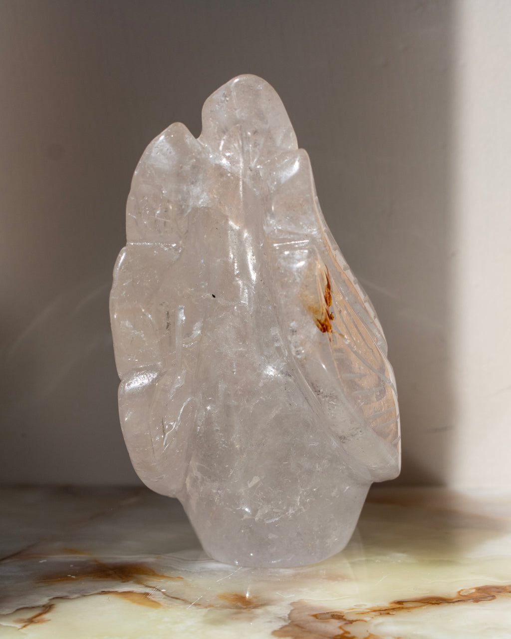 Clear crystal sculpture on a marble surface