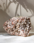 Mineral specimen on a light surface with a neutral background