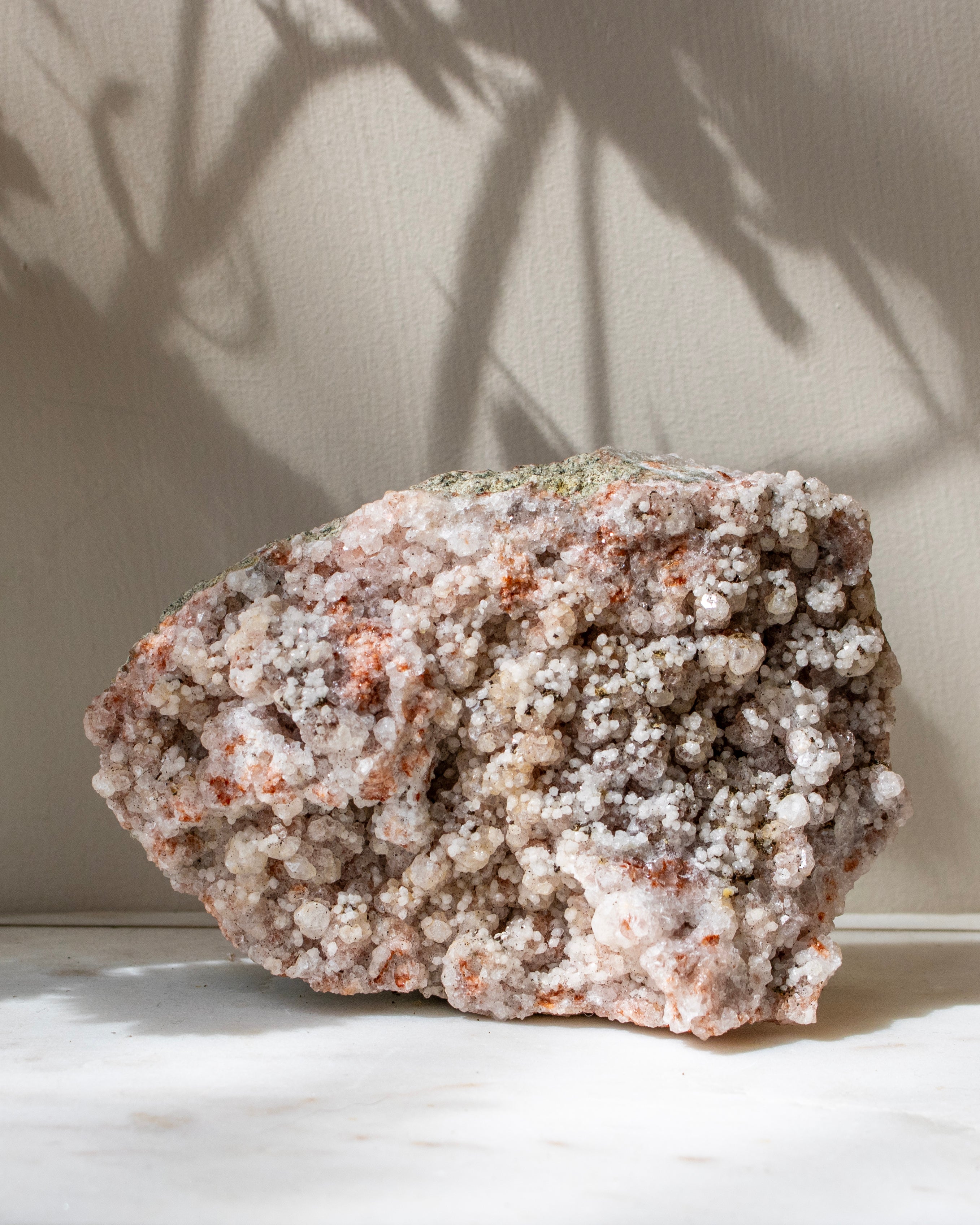 Mineral specimen on a light surface with a neutral background