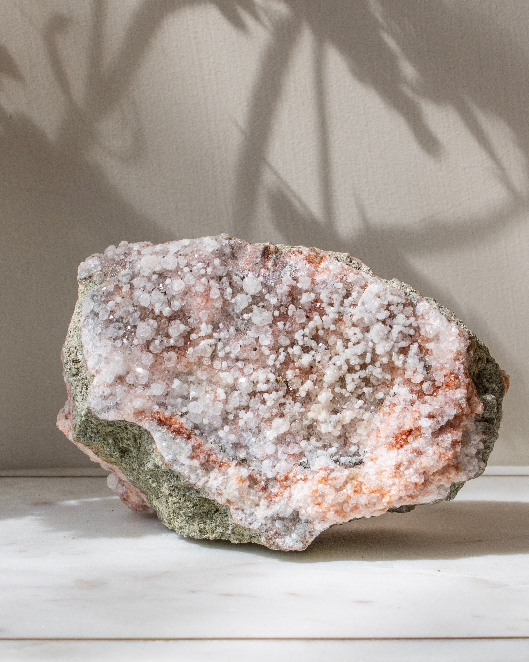 Mineral specimen with a crystalline surface on a neutral background