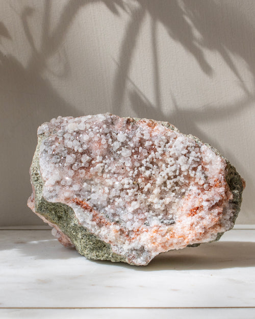 Mineral specimen with a crystalline surface on a neutral background